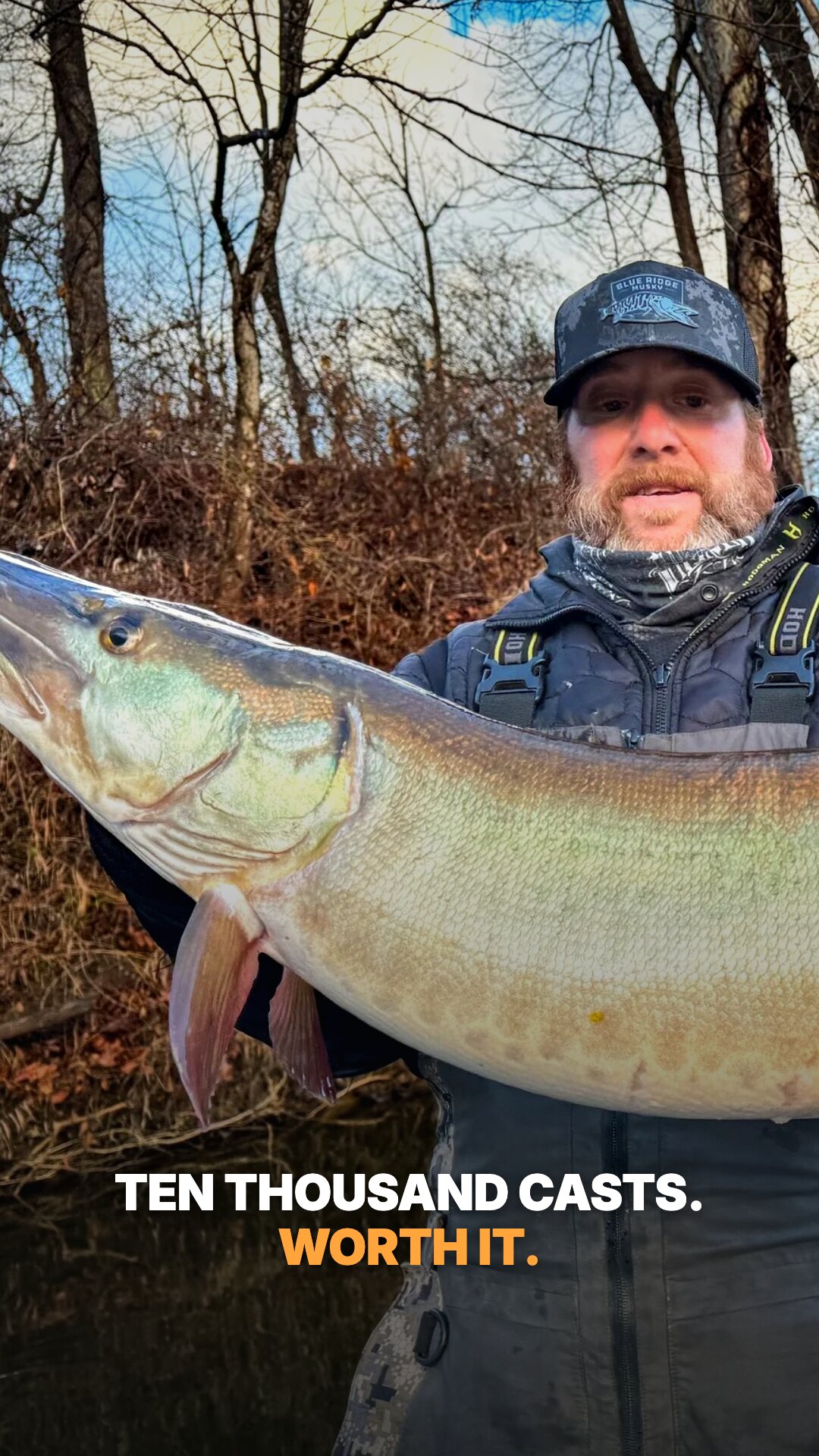 Ad: angler holding a giant musky, hook ten thousand casts worth it (vertical version)