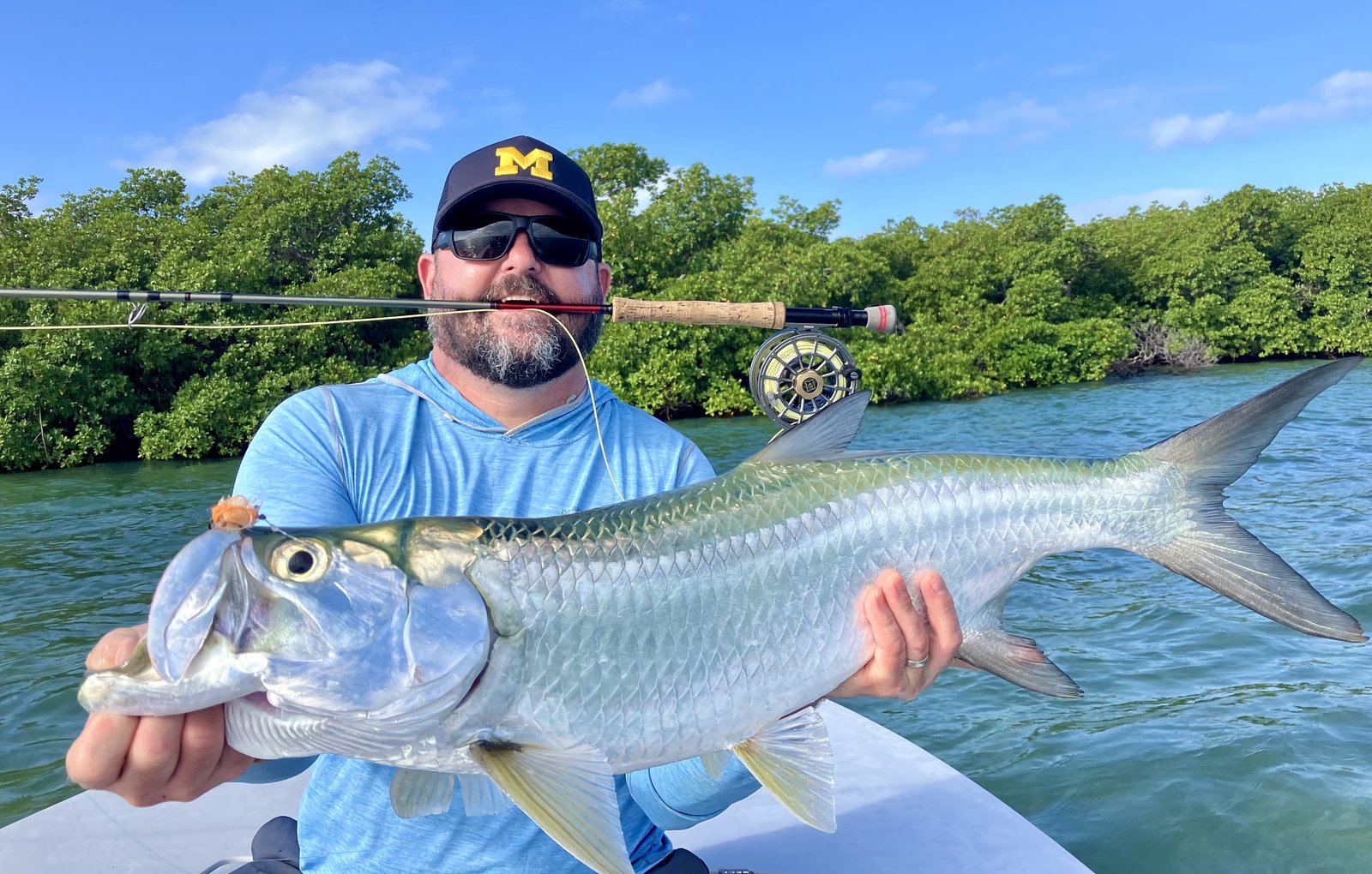 A guide working with a client on the water, photographed by 24/7 Sportfishing in FL
