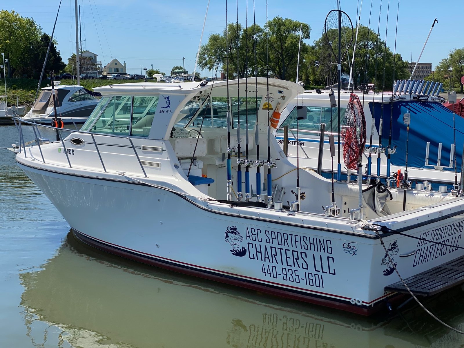 A guide working with a client on the water, photographed by A&C Sportfishing Charters in OH