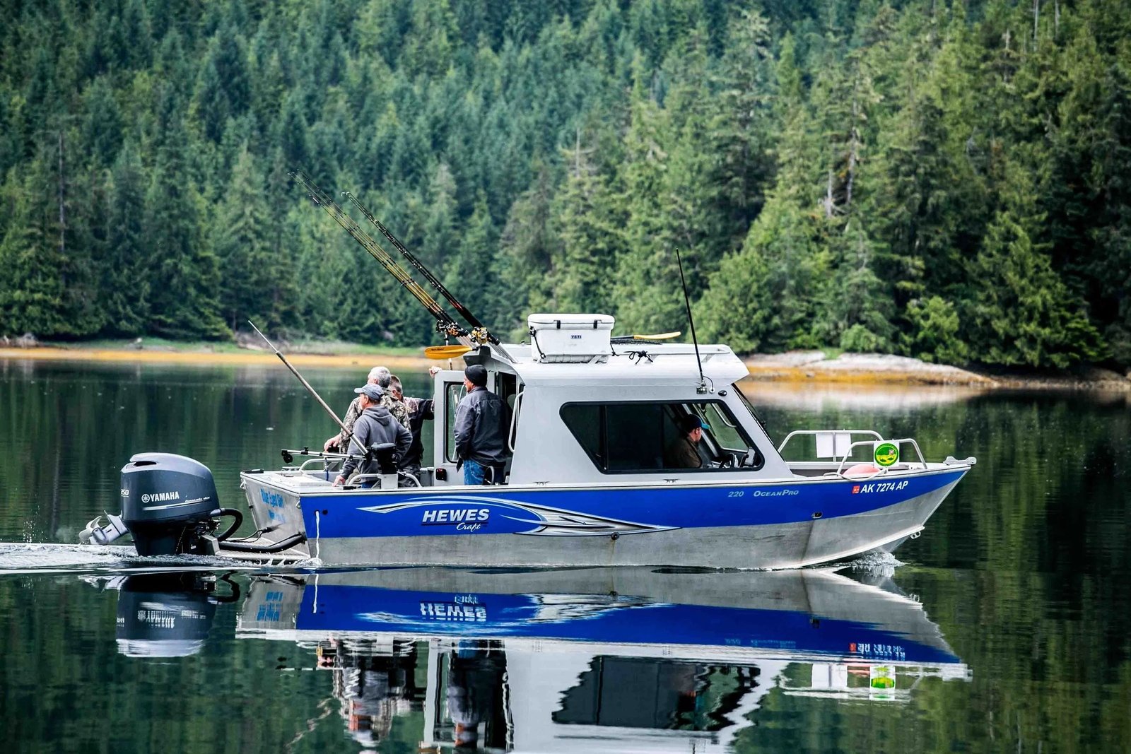 A guide working with a client on the water, photographed by Alaska's Fish Tales Lodge in AK