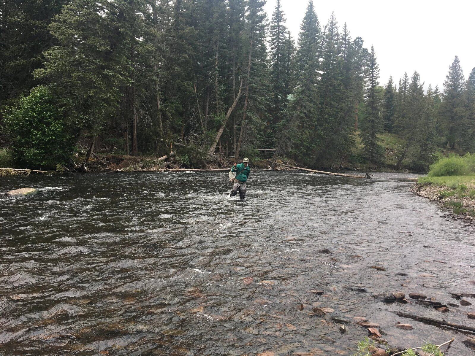A guide working with a client on the water, photographed by Artful Angler in NM