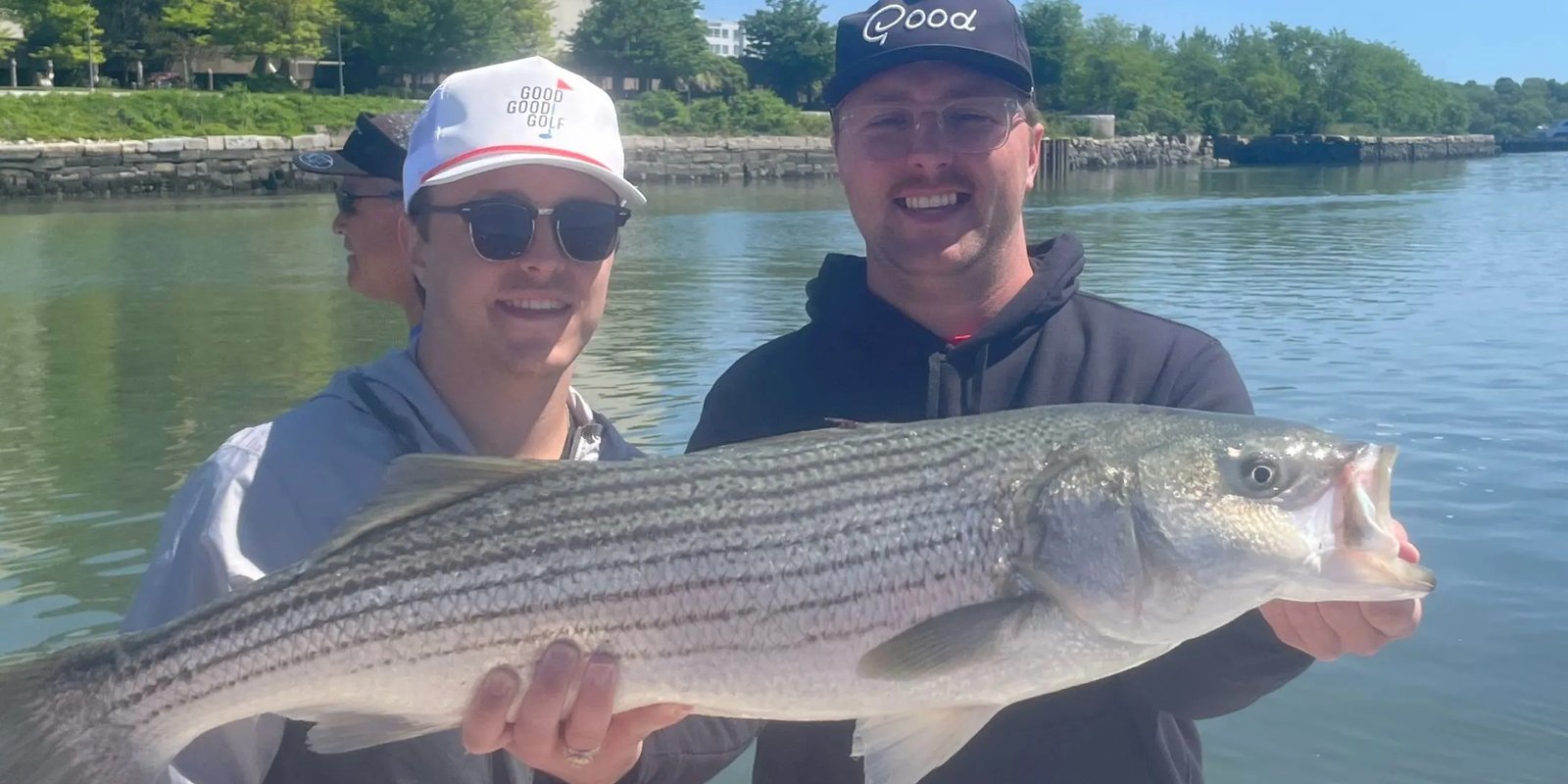 A guide working with a client on the water, photographed by Blue Line Fishing Charters in MA