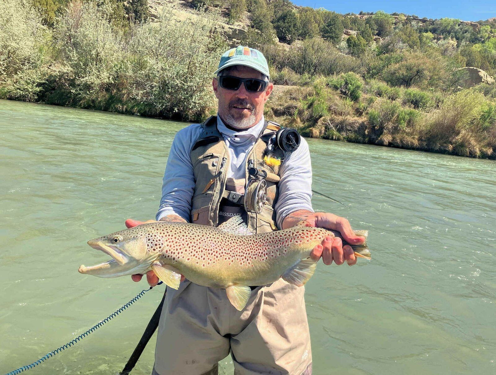A guide working with a client on the water, photographed by Blue Sky Fly Fishing Co. in NM