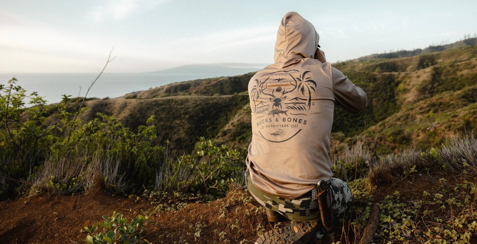 An angler fishing under a guide's direction, photographed by Bucks & Bones Outfitters in HI