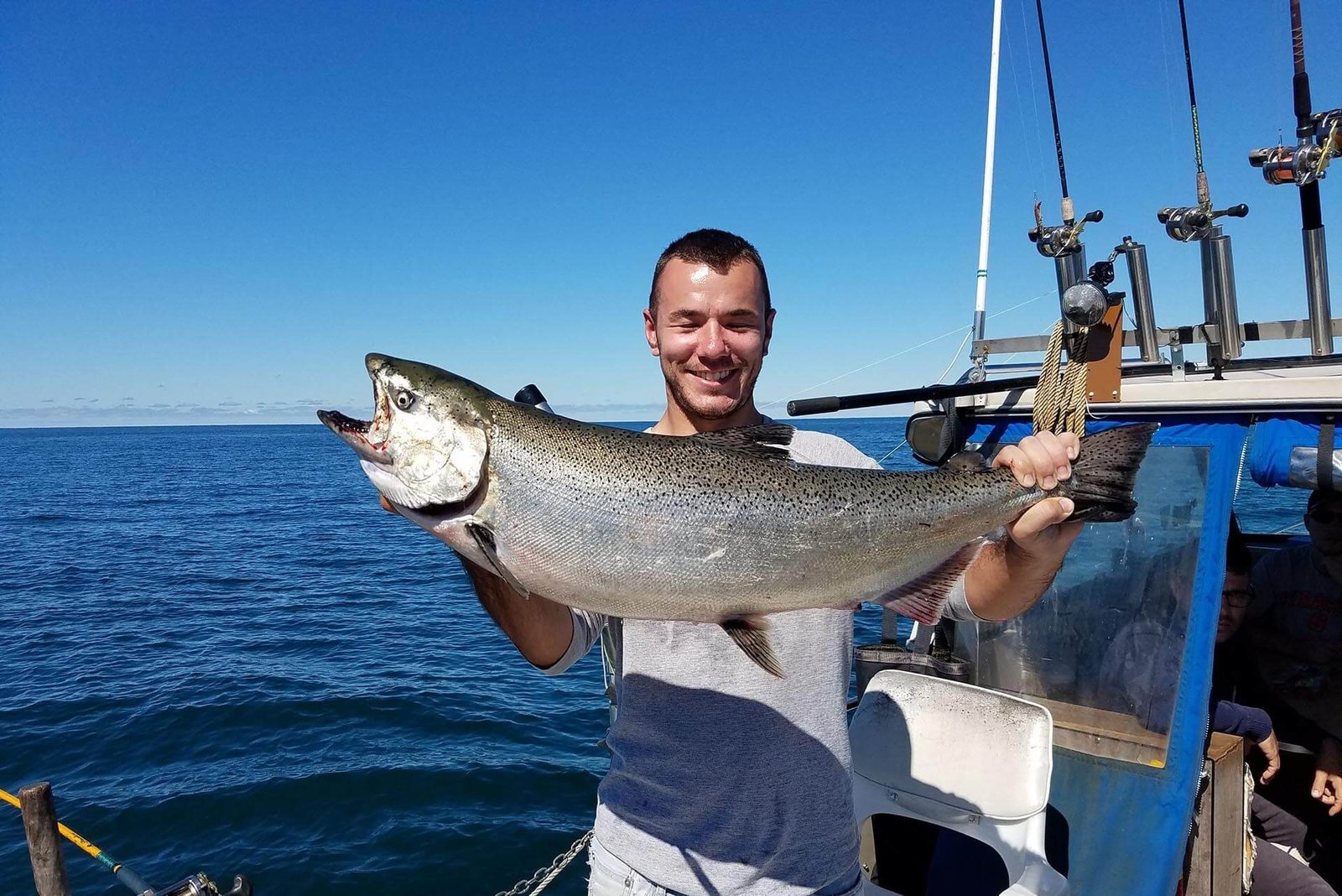 A guide working with a client on the water, photographed by Catfish Creek Fishing Camp in NY