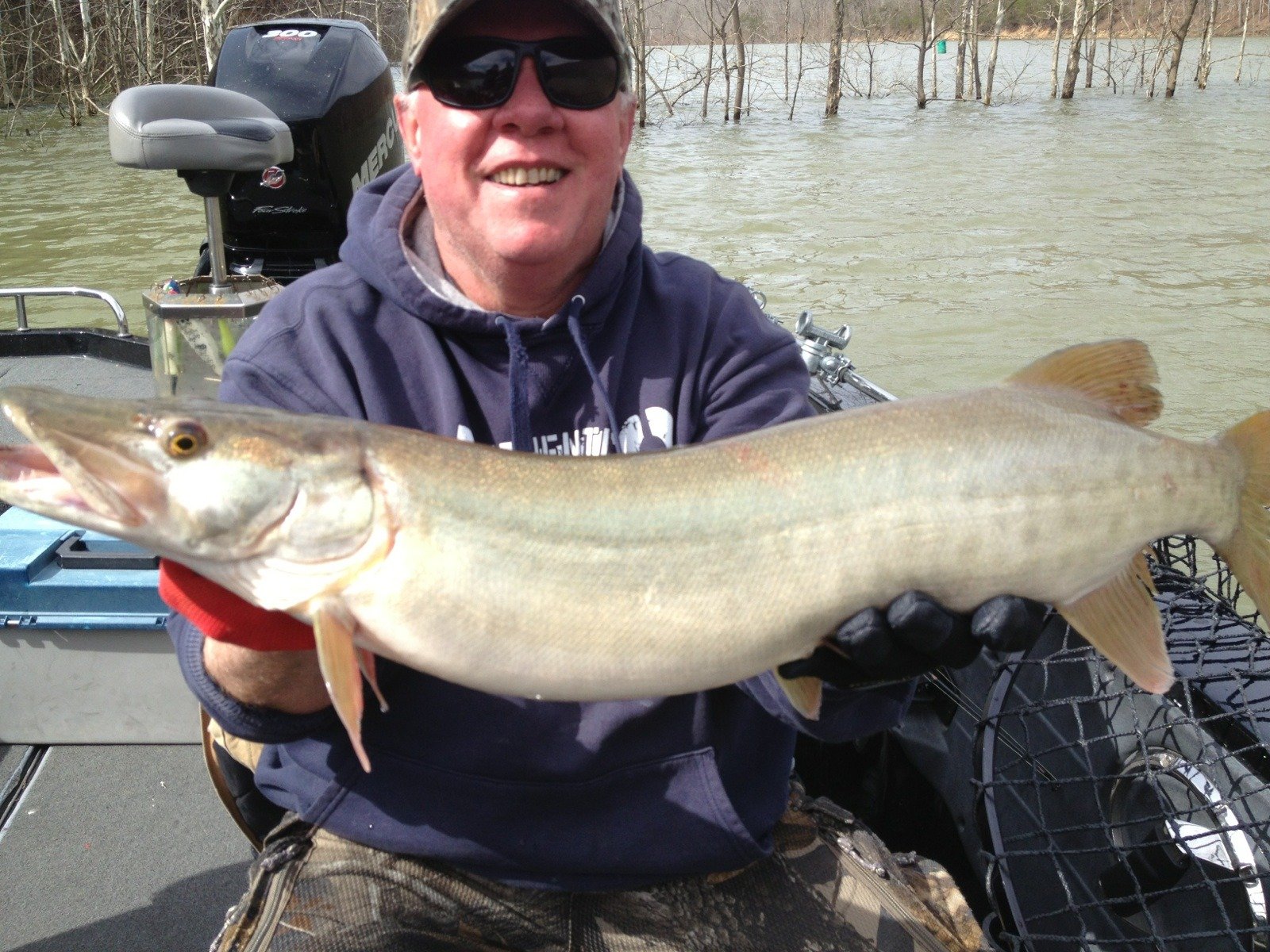 A guide working with a client on the water, photographed by Cave Run Muskie Guide Service in KY