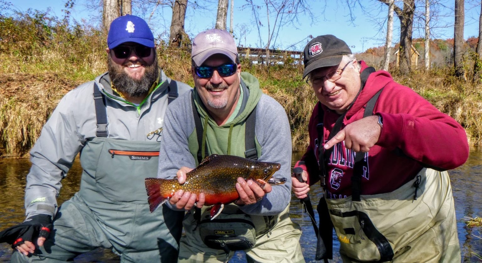 A guide working with a client on the water, photographed by Curtis Wright Outfitters & Fly Fishing Guides in NC