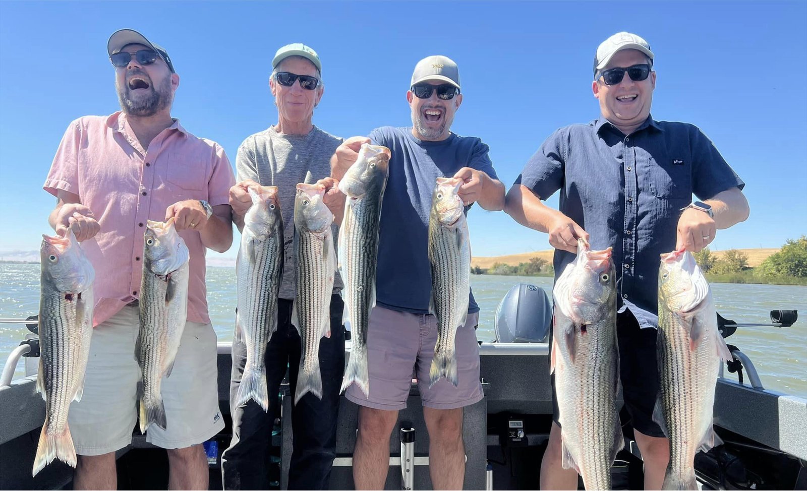 A guide working with a client on the water, photographed by Delta SportFishing in CA