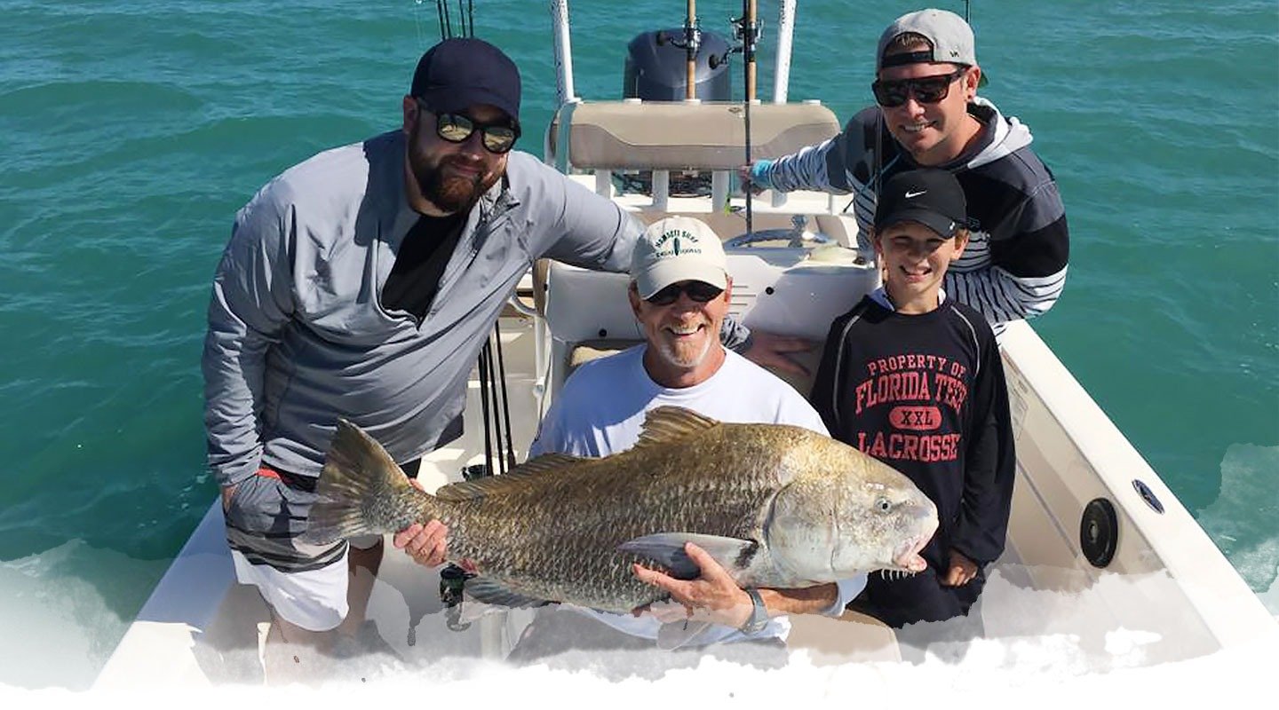 A guide working with a client on the water, photographed by Fin & Fly Fishing Charters in FL