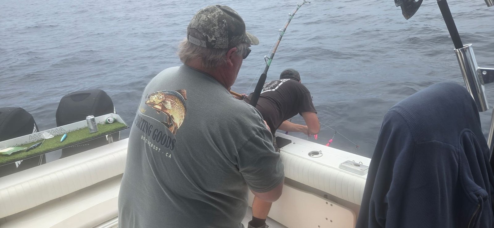 A guide working with a client on the water, photographed by Fish Further Charters in CA
