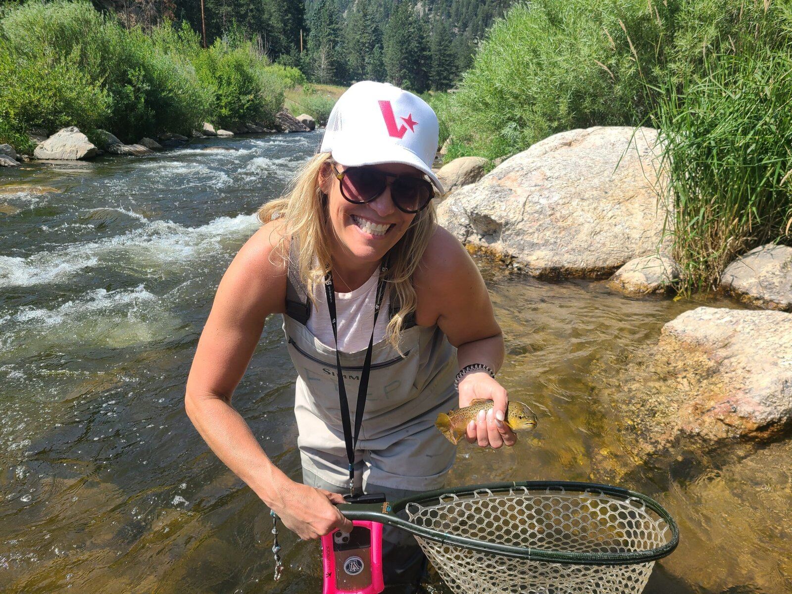 A guide working with a client on the water, photographed by Fly Fish Estes Park in CO
