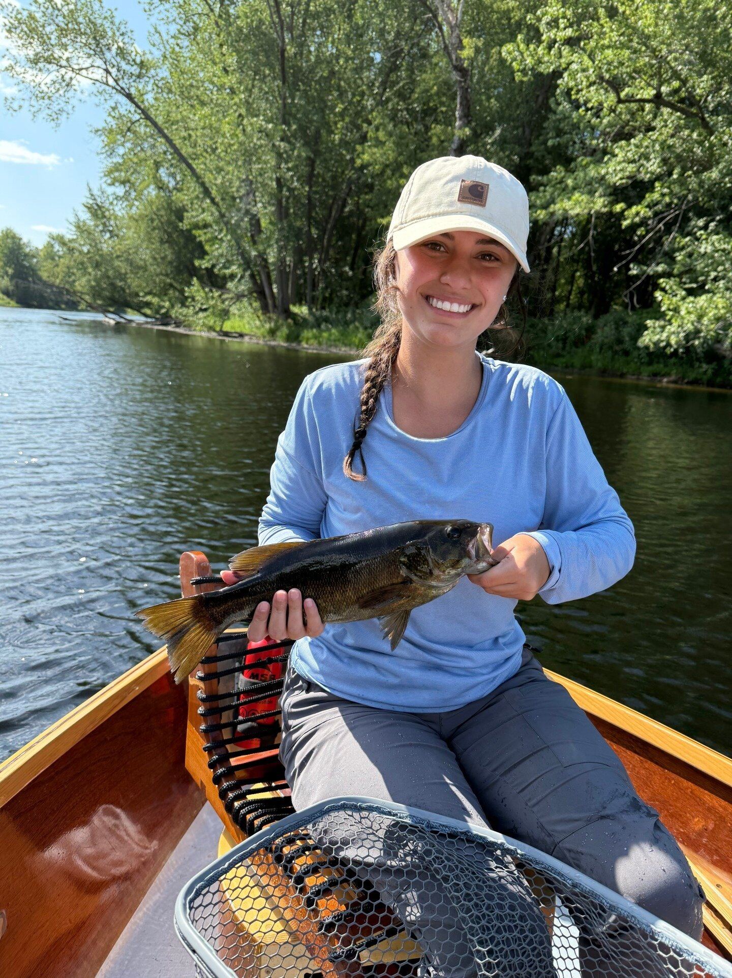 A guide working with a client on the water, photographed by Gallandt Fly Fishing in ME