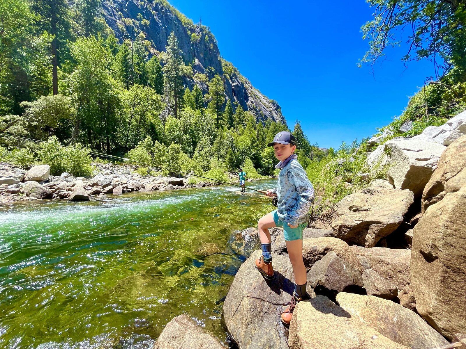 A guide working with a client on the water, photographed by Gregory Nespor Fly Fishing in CA