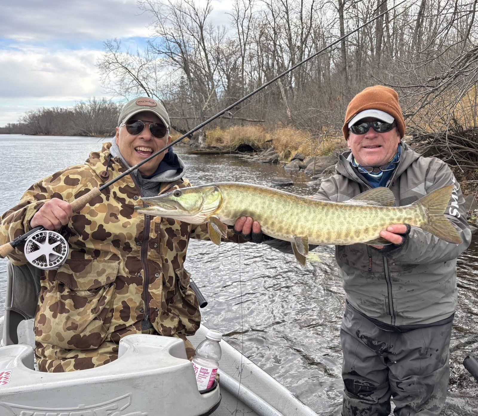A guide working with a client on the water, photographed by Headwaters Fly Fishing Co. in MN