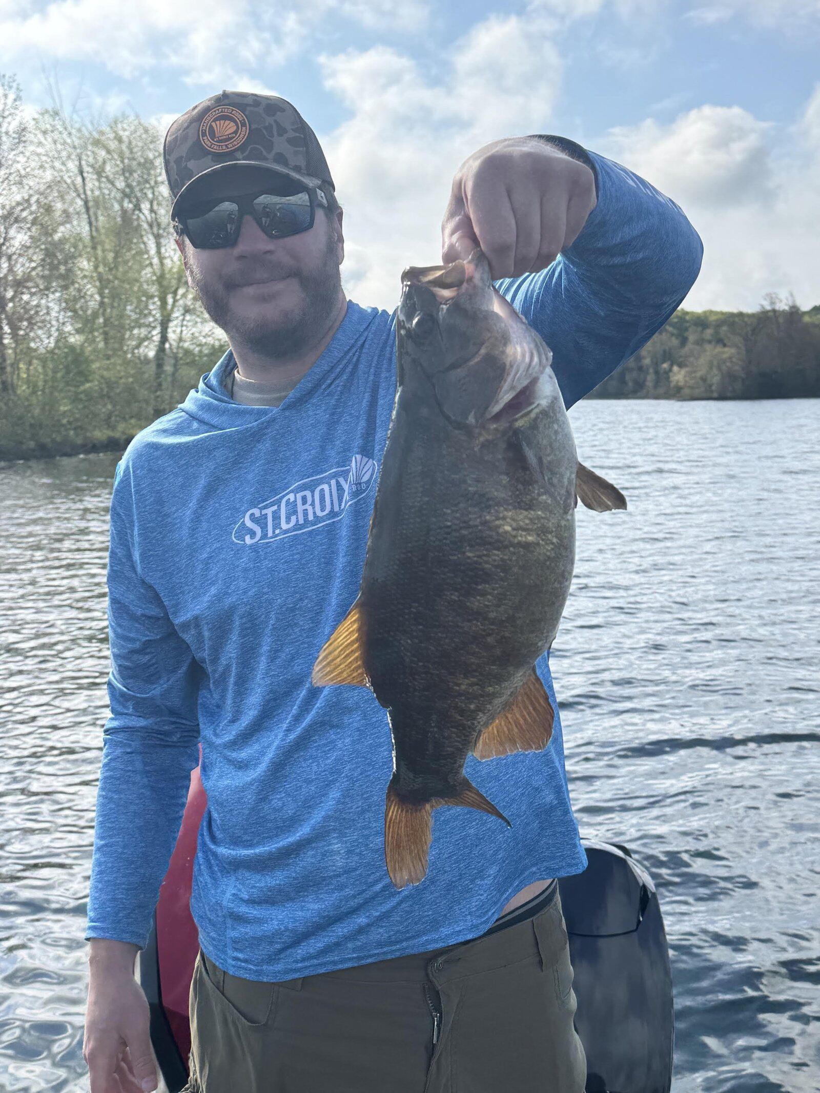 A guide working with a client on the water, photographed by Hendo's Angling in WI