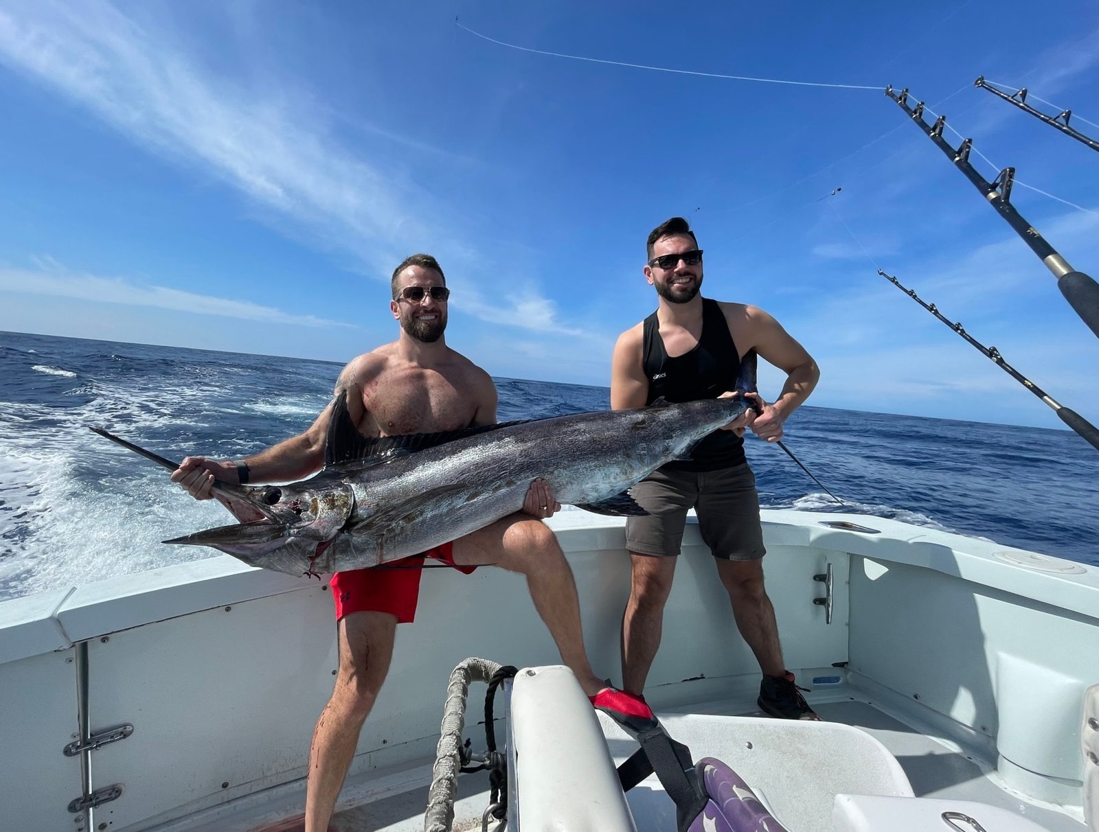 A guide working with a client on the water, photographed by High Noon Sportfishing in HI