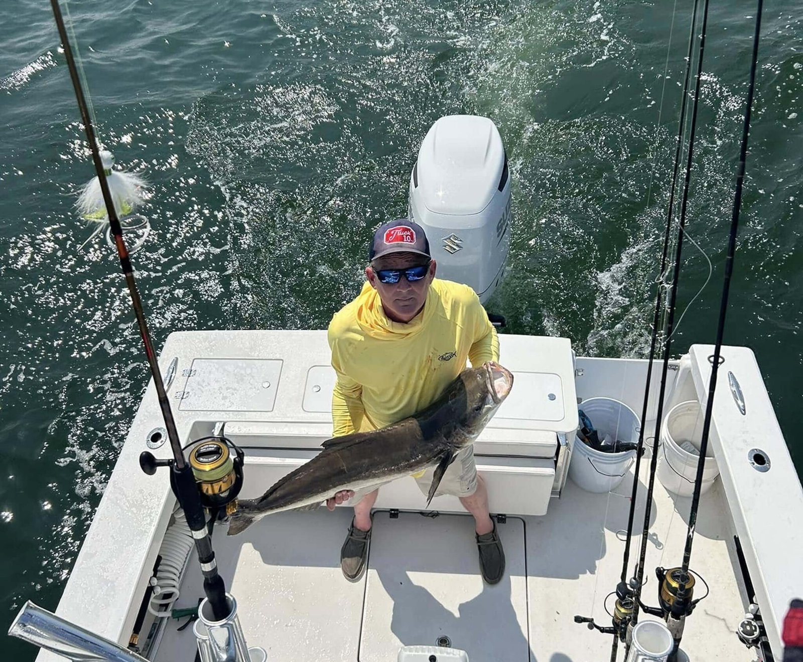 A guide working with a client on the water, photographed by Hookz Sportfishing in VA