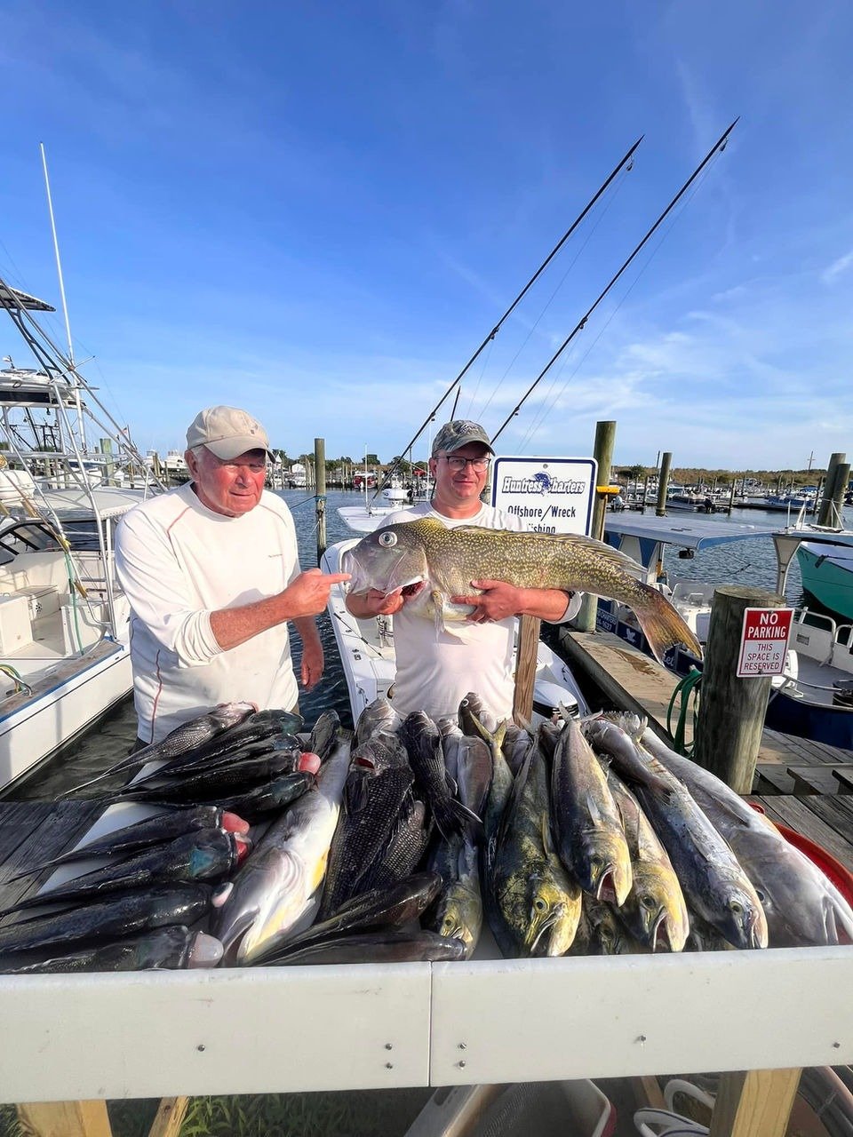 A guide working with a client on the water, photographed by Huntress Charters in VA