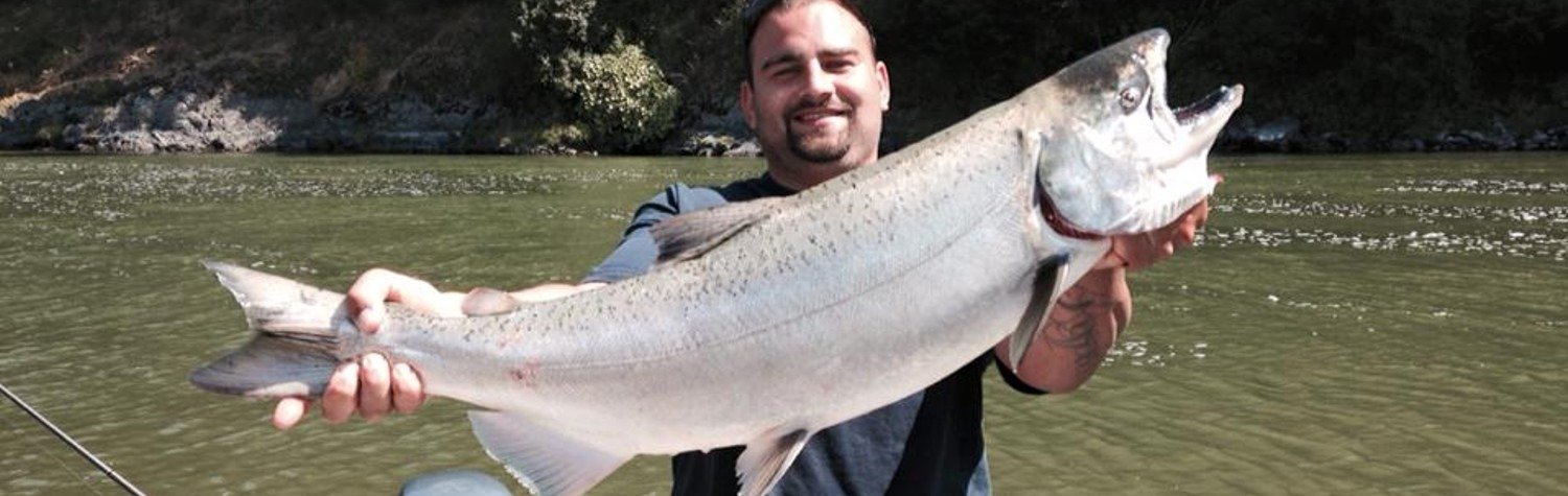 A guide working with a client on the water, photographed by James Keeling Fishing Guide Service in CA