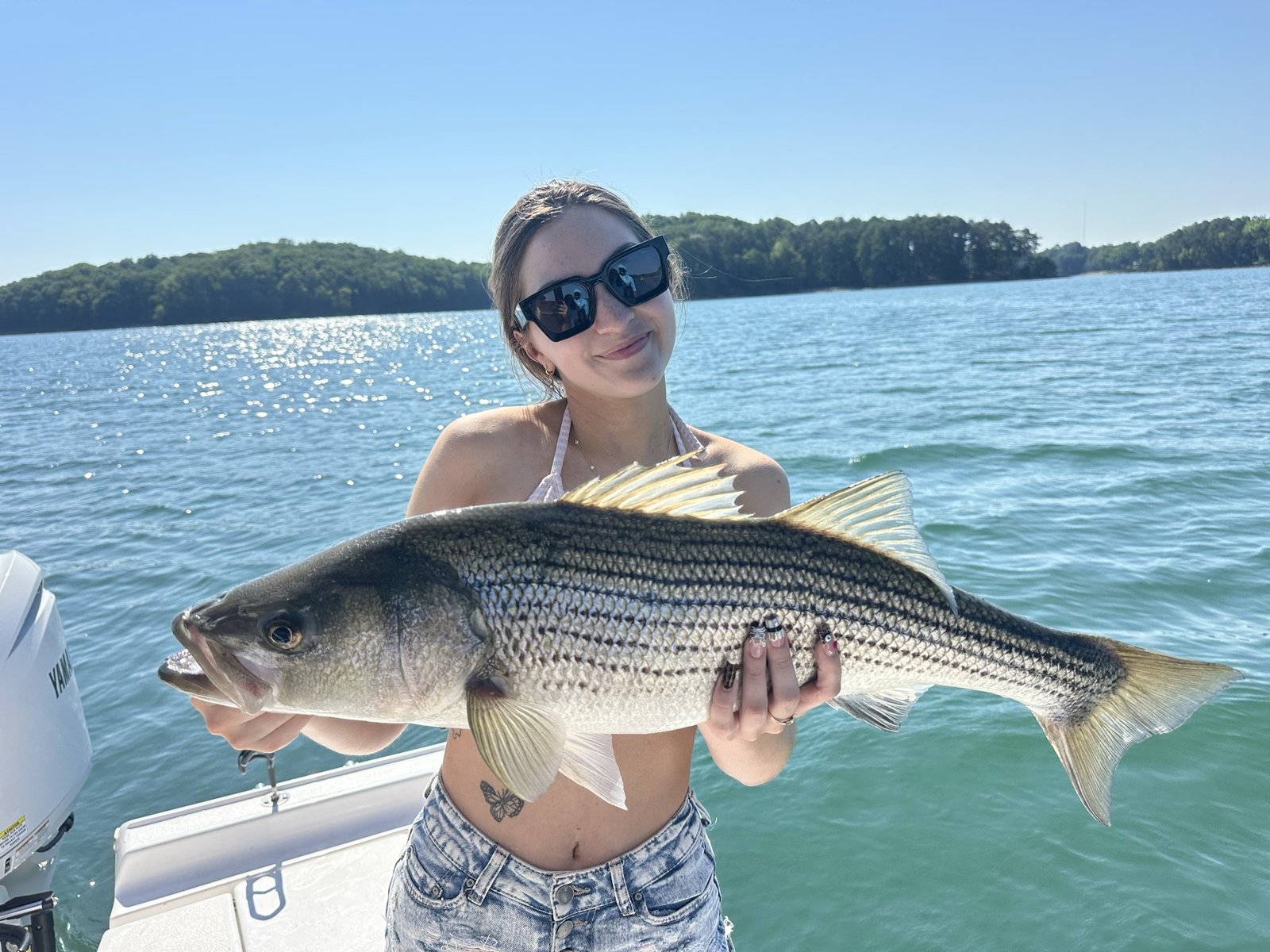 A guide working with a client on the water, photographed by Jeff Blair Striper Guides in GA