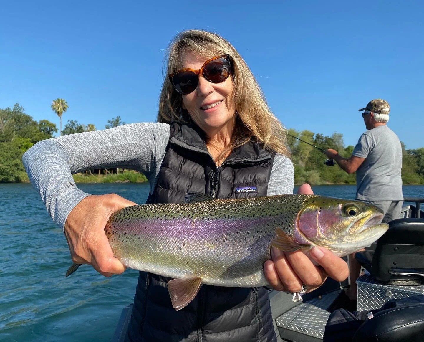 A guide working with a client on the water, photographed by Justin Thompson Fishing in CA