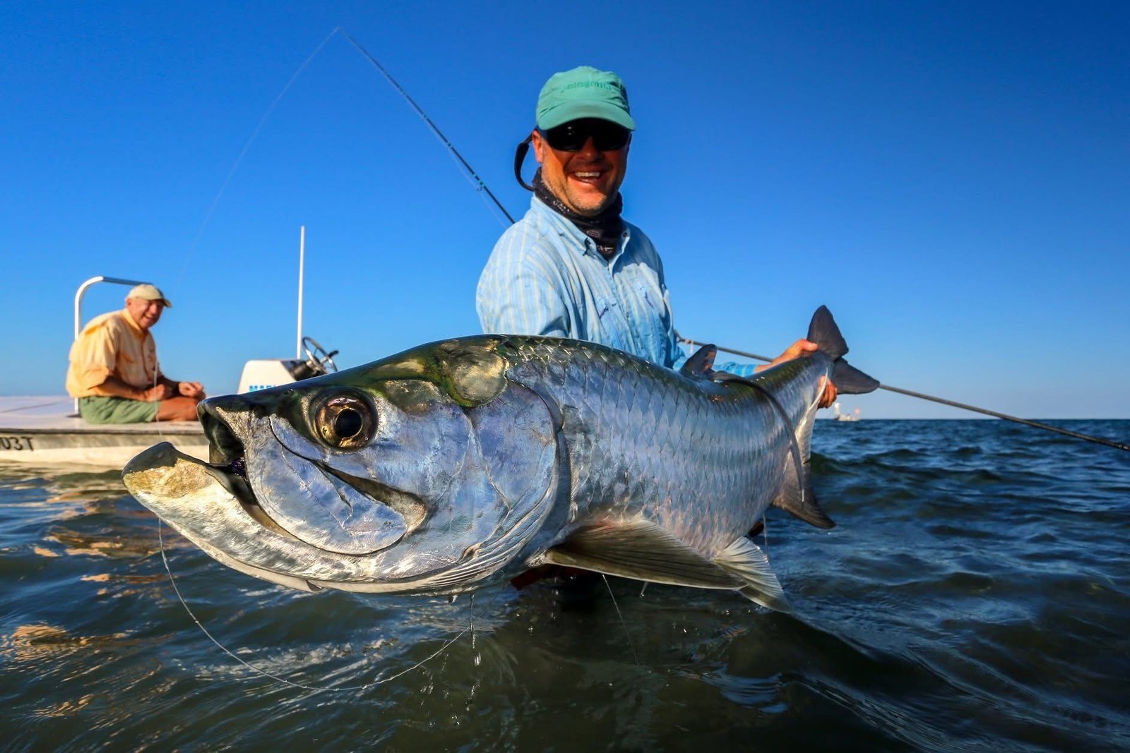 A guide working with a client on the water, photographed by Key West Fly Fishing in FL