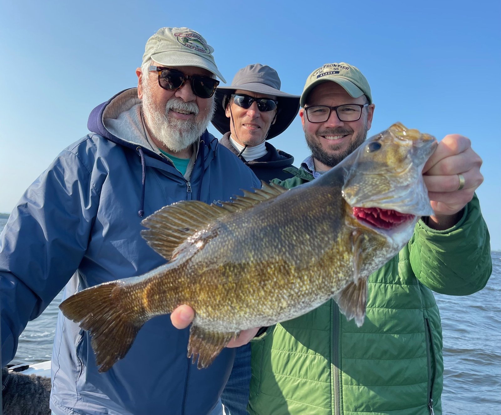 A guide working with a client on the water, photographed by Lake Champlain Angler Fishing Charters in NY