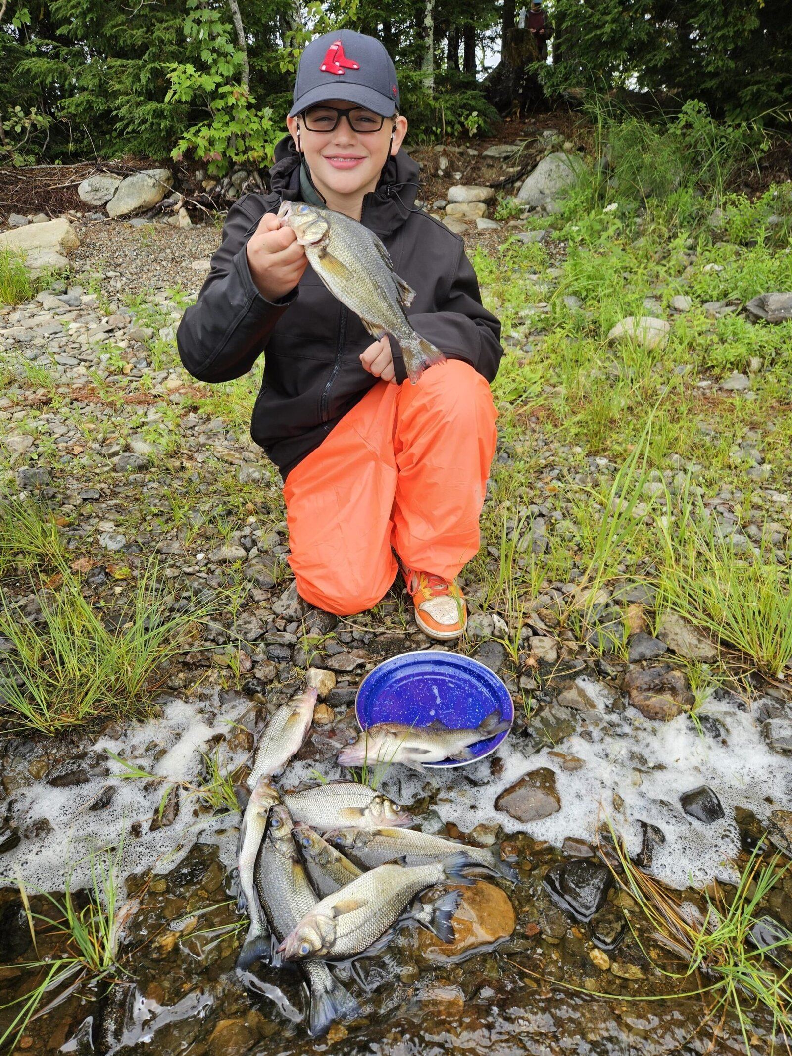 A guide working with a client on the water, photographed by Long Lake Camps in ME