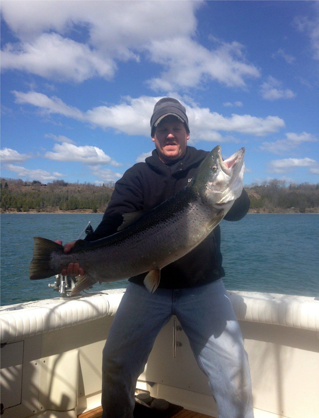 A guide working with a client on the water, photographed by Lori's Pride Charters in WI