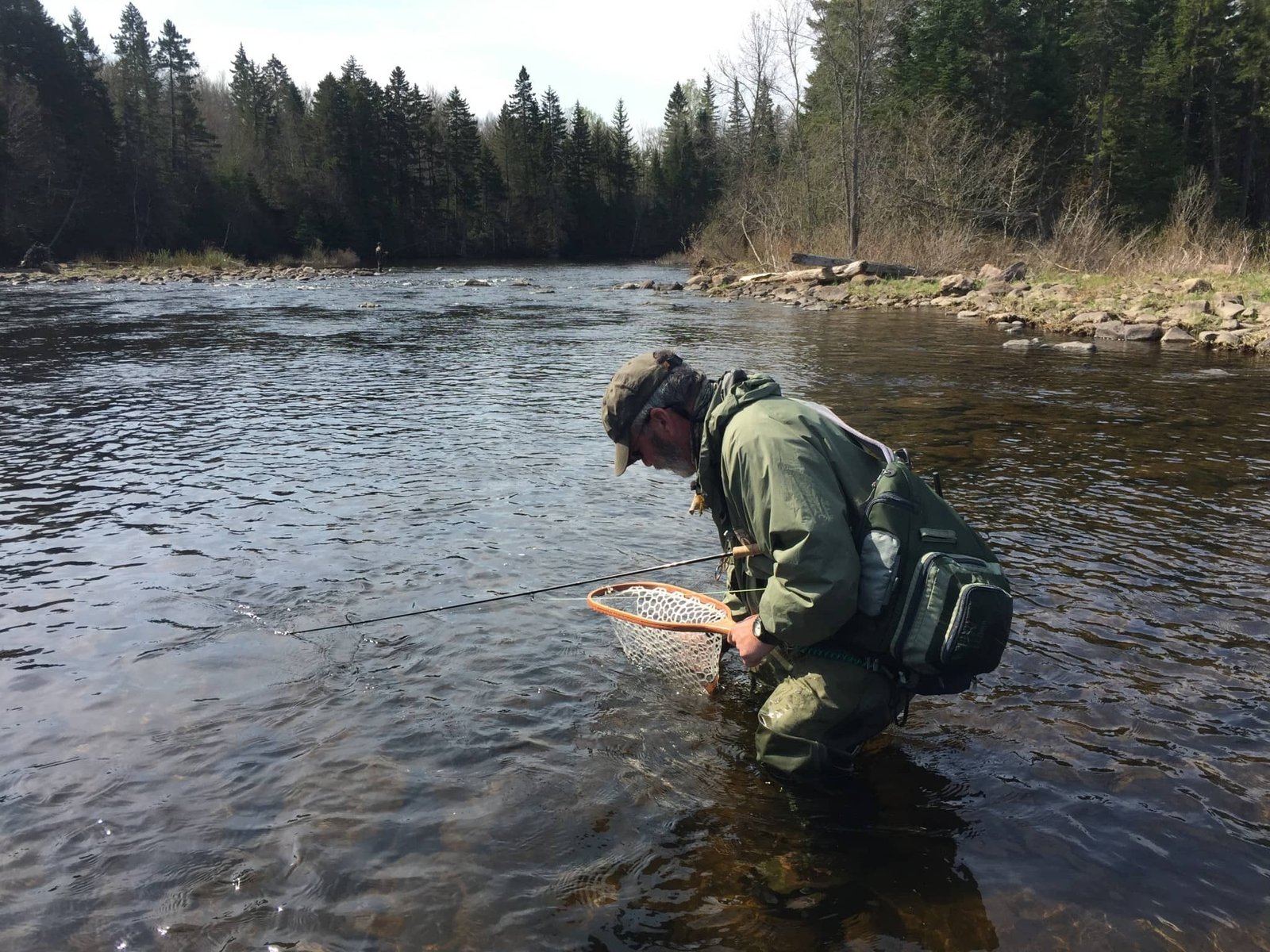 A guide working with a client on the water, photographed by Magalloway Guide Service in ME
