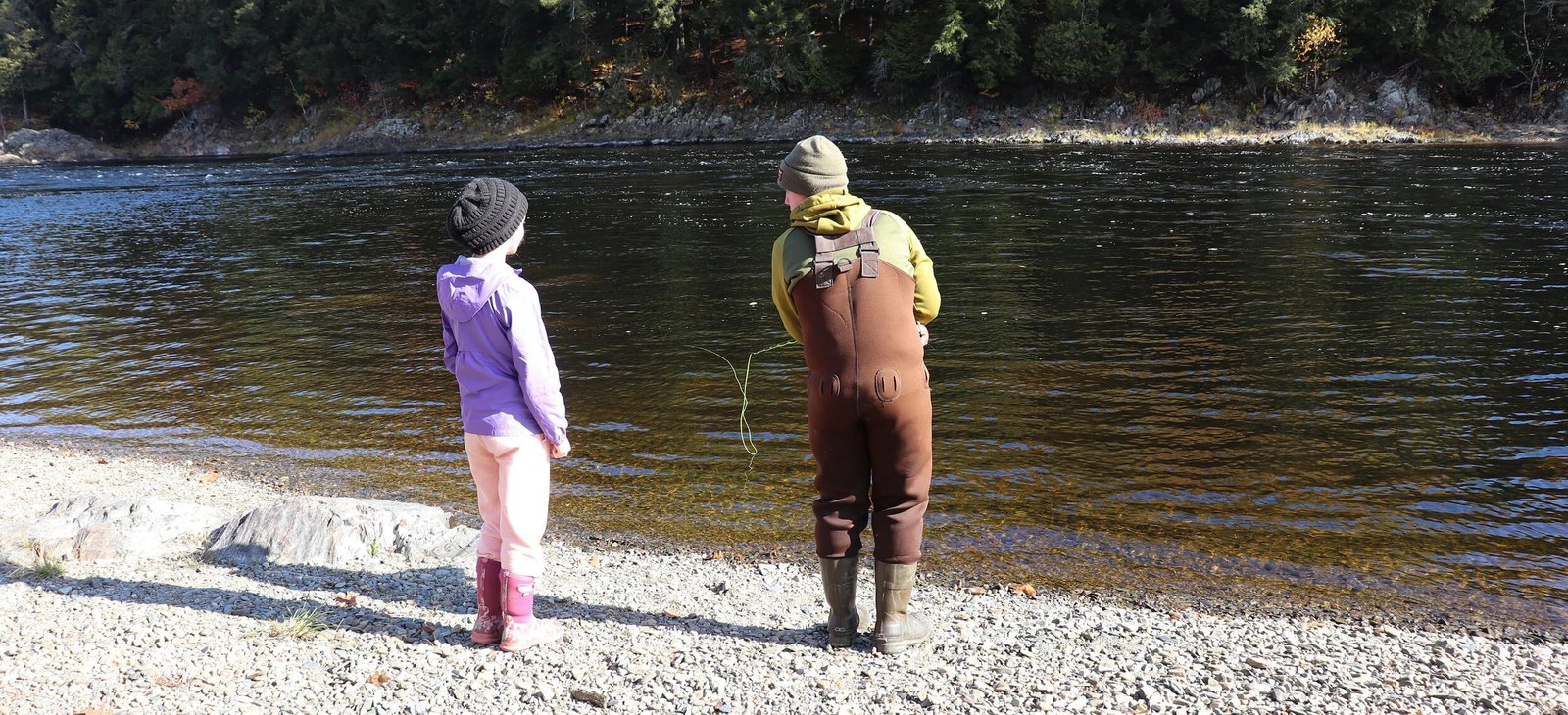 A guide working with a client on the water, photographed by Maine Fishing Guides in ME