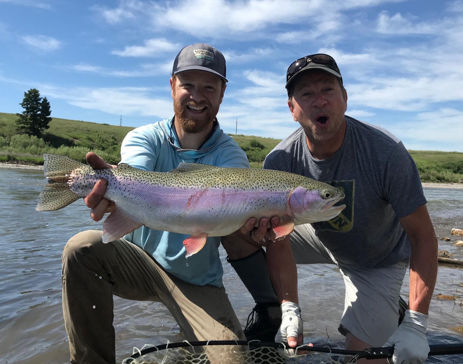 A guide working with a client on the water, photographed by Montana Fly Guides in MT