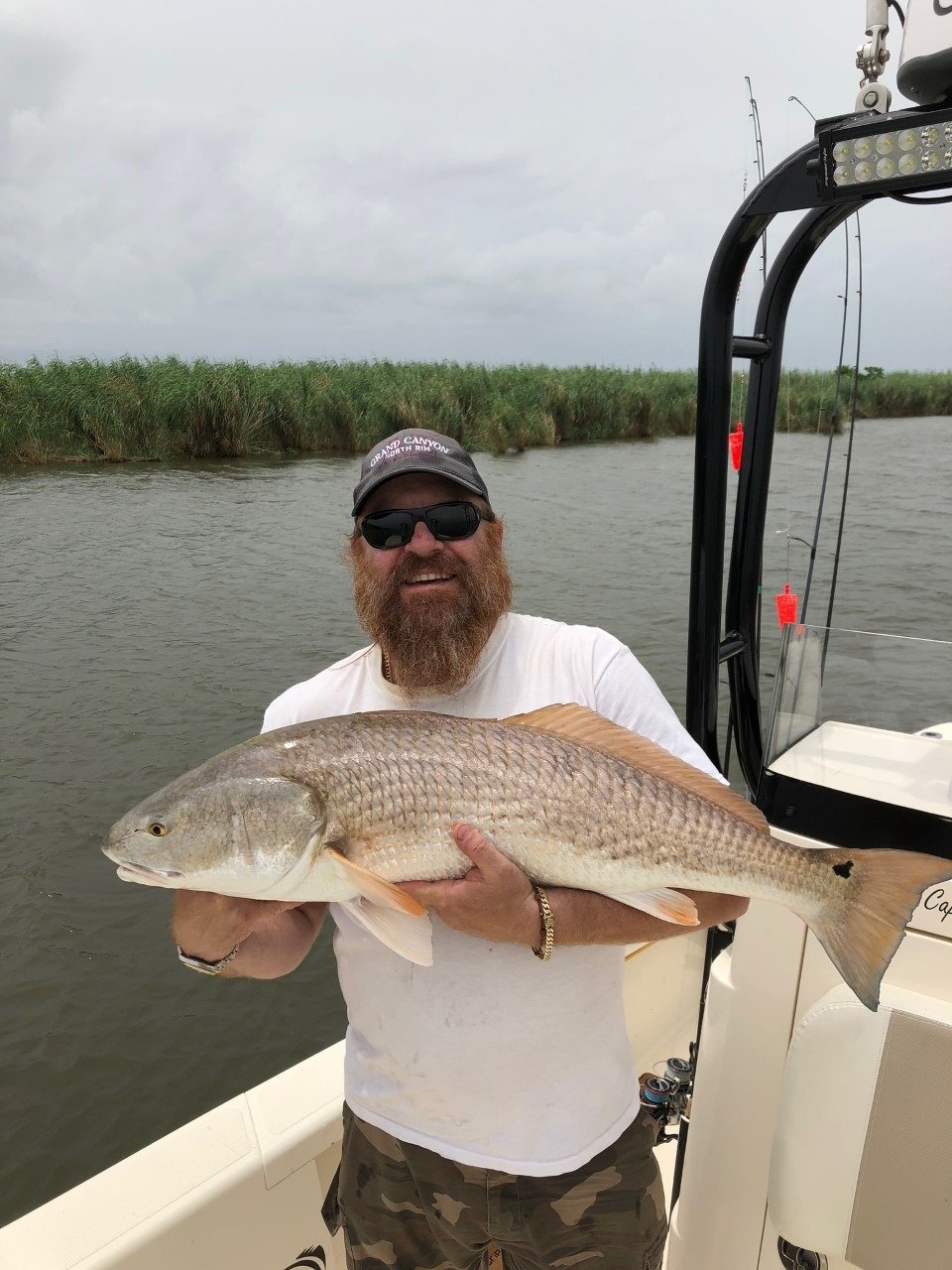 A guide working with a client on the water, photographed by On A Mission Fishin Charters in LA