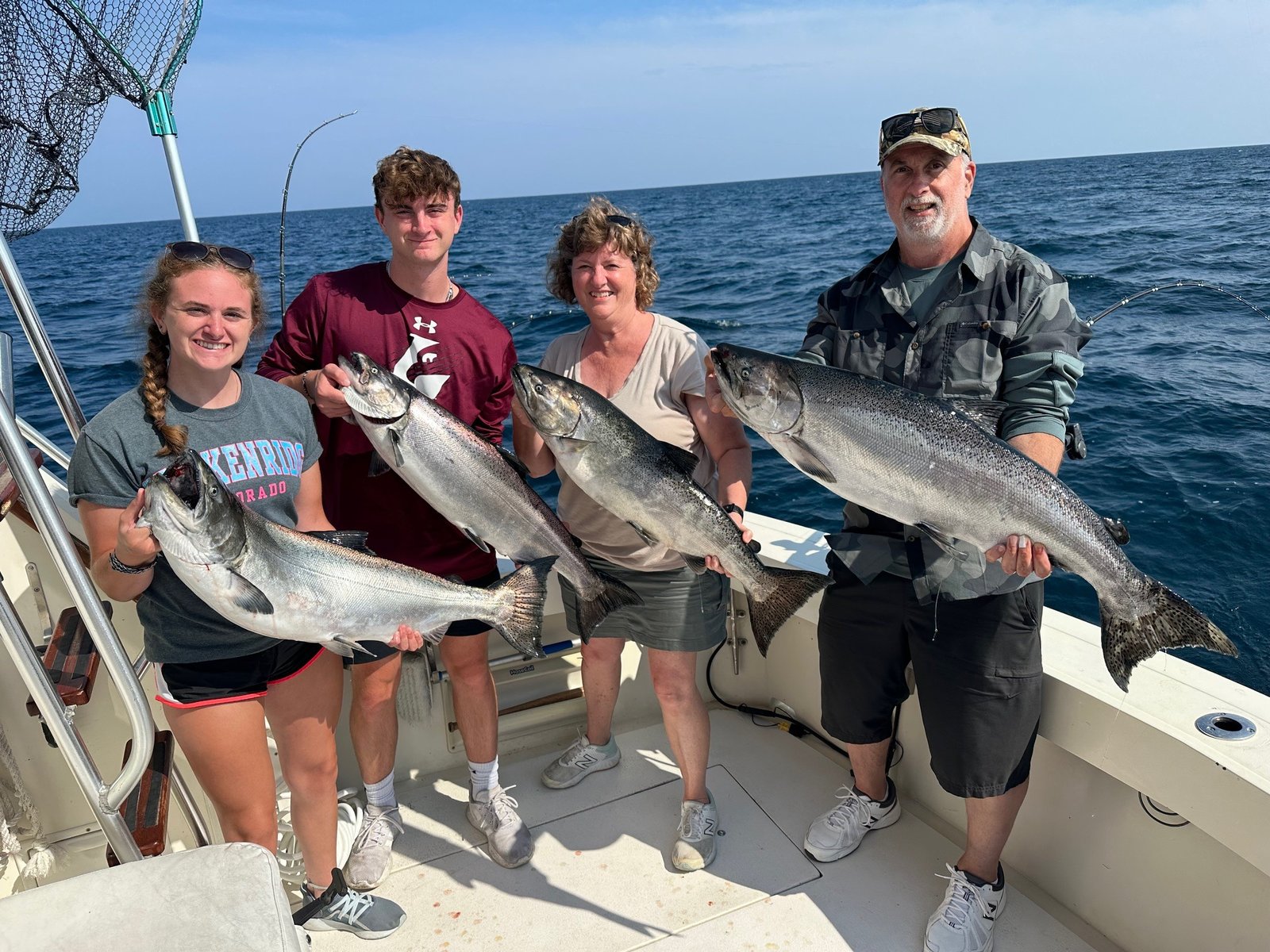 A guide working with a client on the water, photographed by Reel Impression Sportfishing Charters in WI