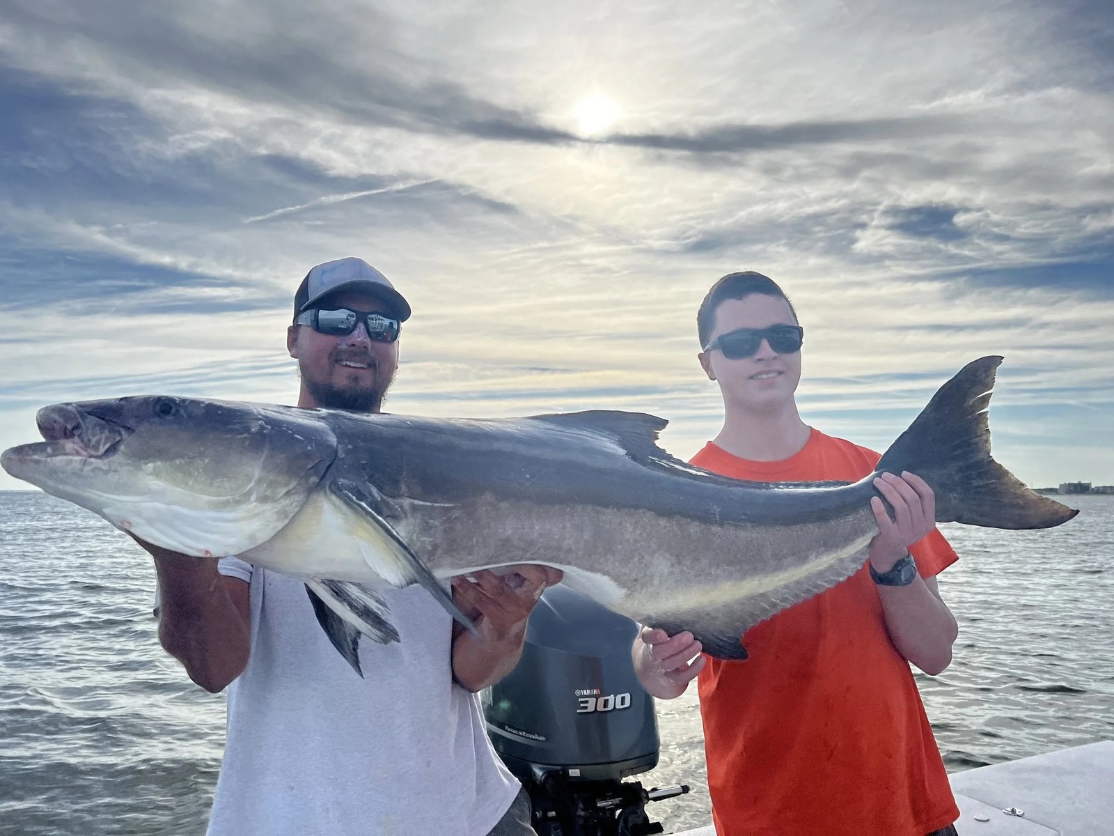 A guide working with a client on the water, photographed by Reel Release Sportfishing in VA