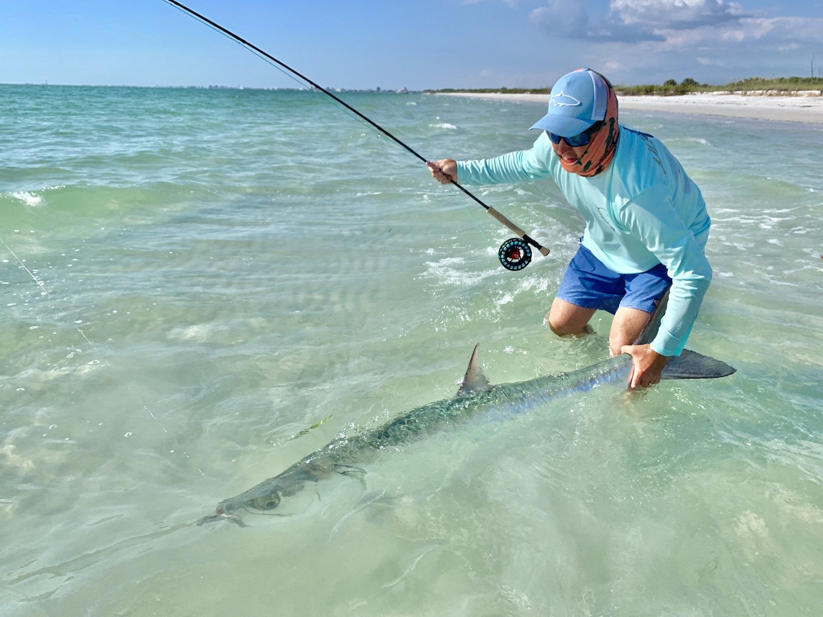 A guide working with a client on the water, photographed by Shallow Water Fly Fishing in FL