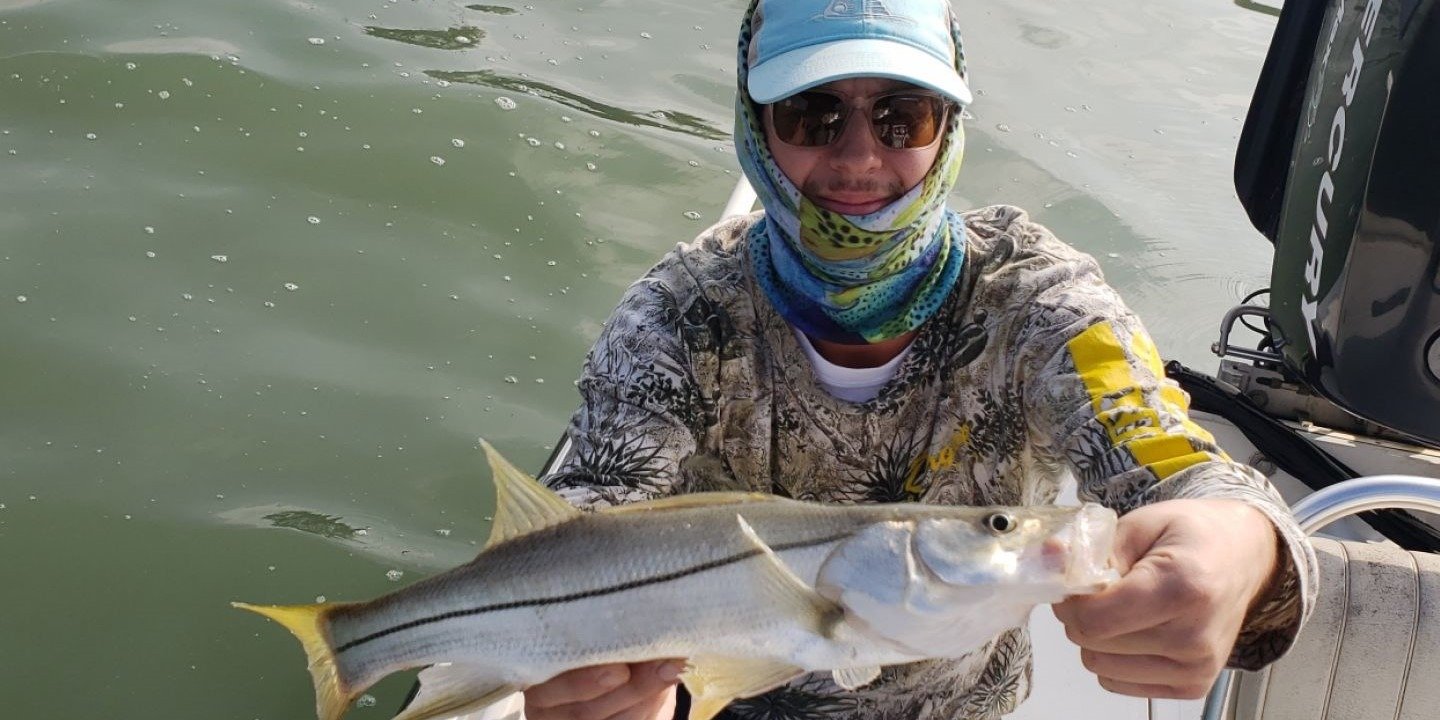 A guide working with a client on the water, photographed by Snook On A Hook in TX