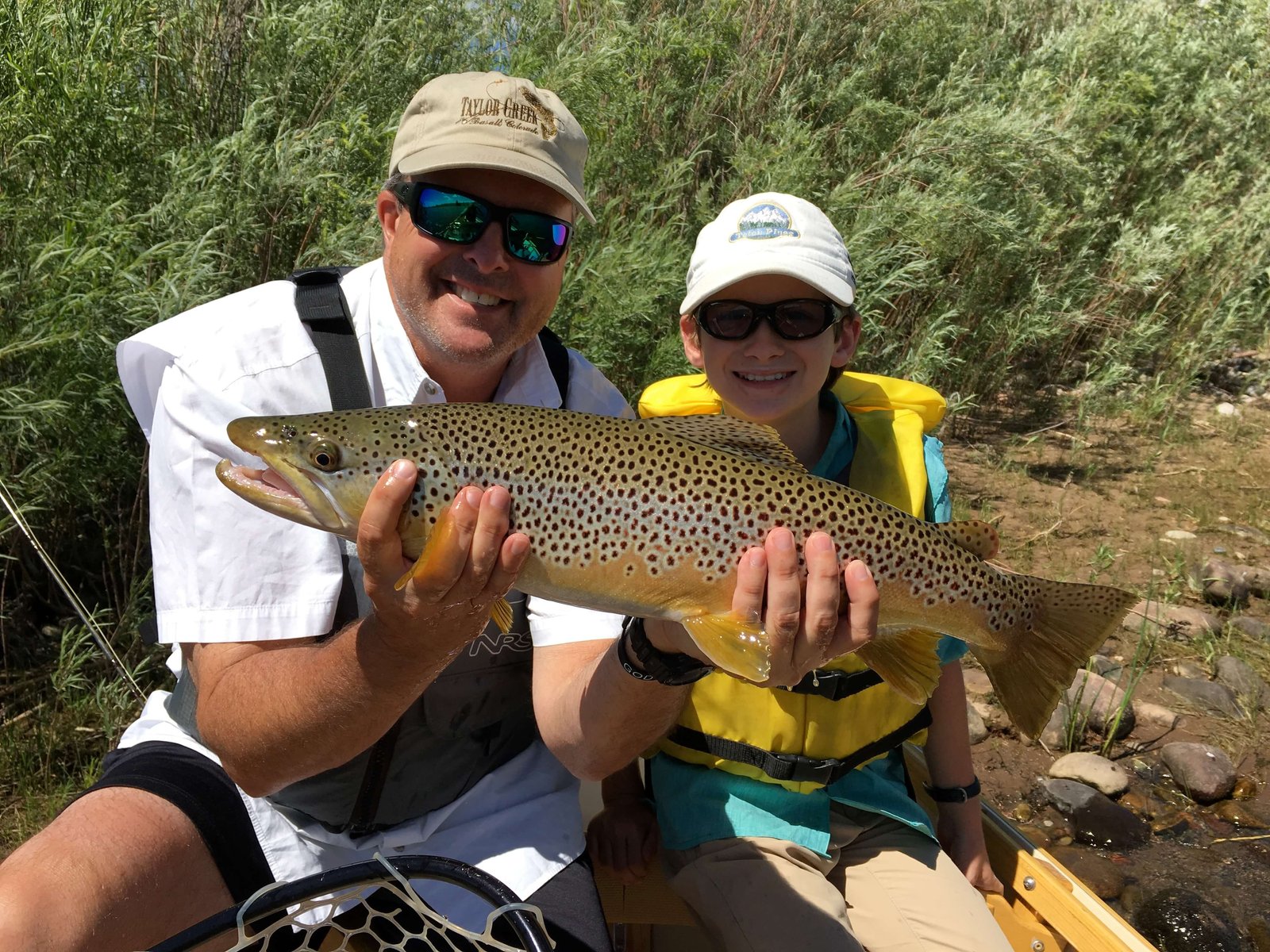 A guide working with a client on the water, photographed by Sopris Fishing Outfitters in CO