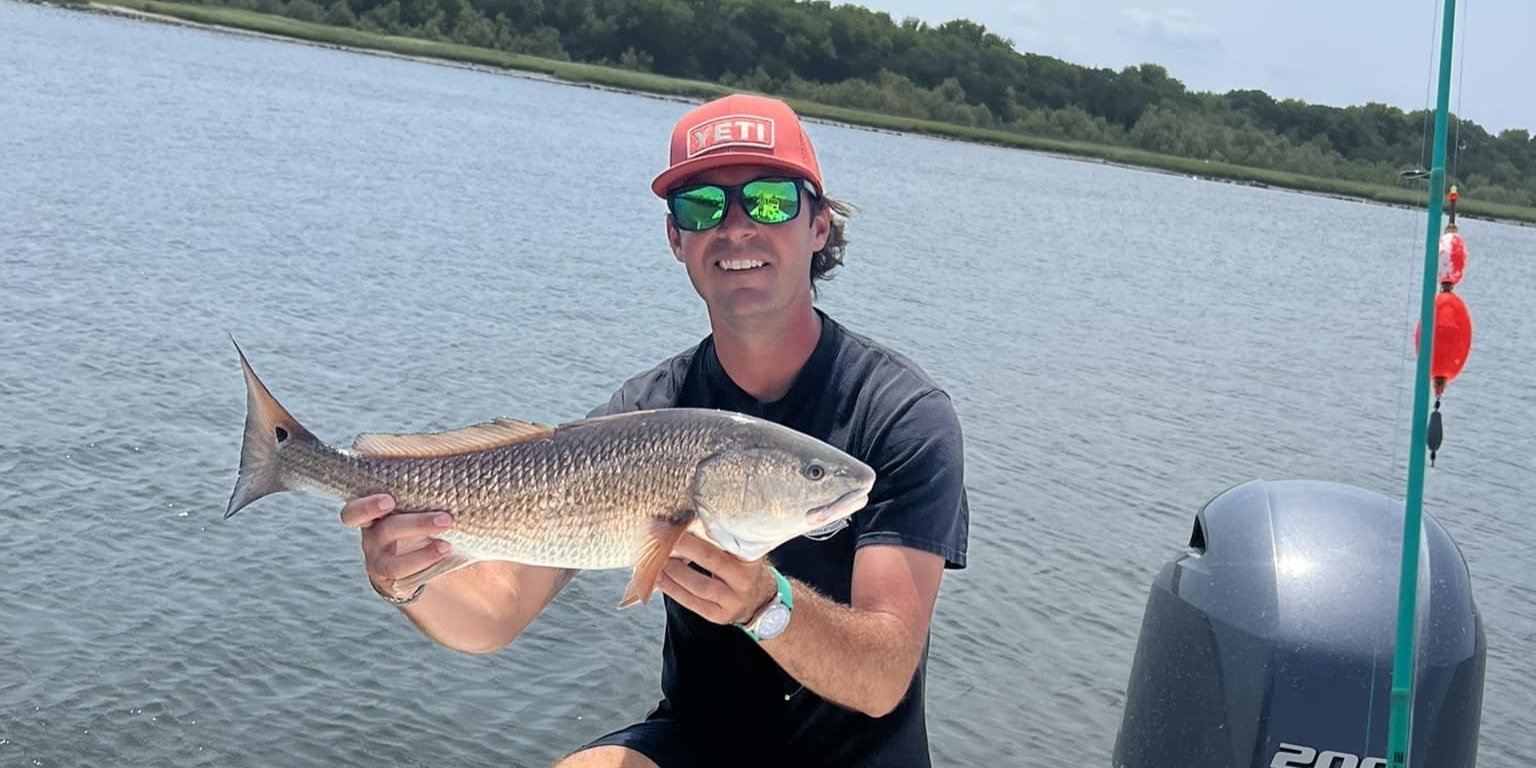 A guide working with a client on the water, photographed by Southern Sport Fishing Charters in GA