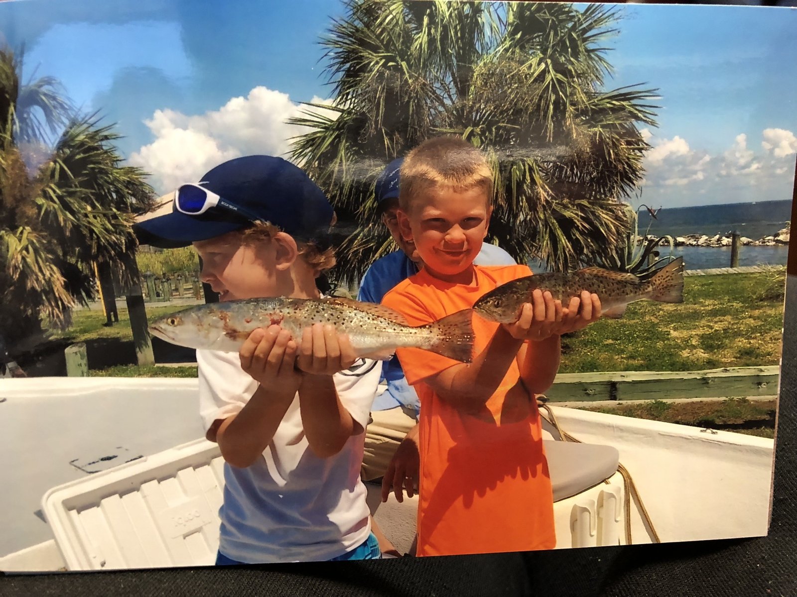 A guide working with a client on the water, photographed by Spots Dots and Scales Inshore Fishing Charters in AL