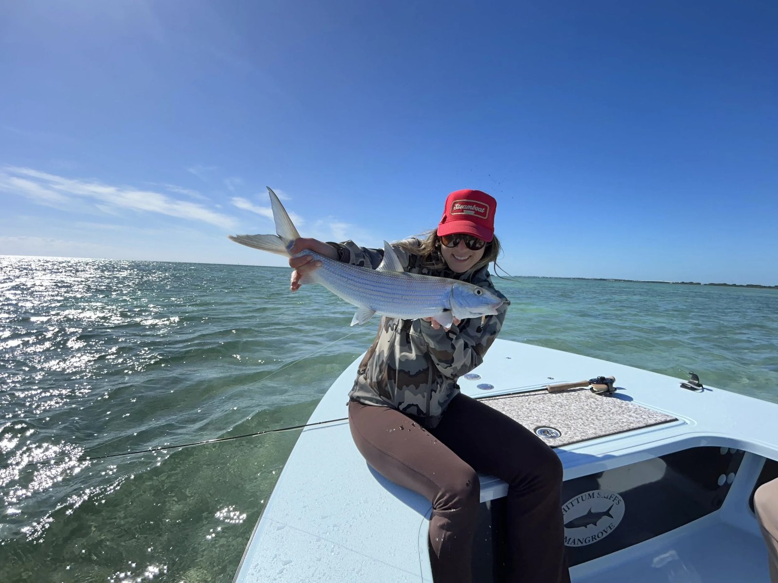 A guide working with a client on the water, photographed by StayFly Inshore Fishing in FL