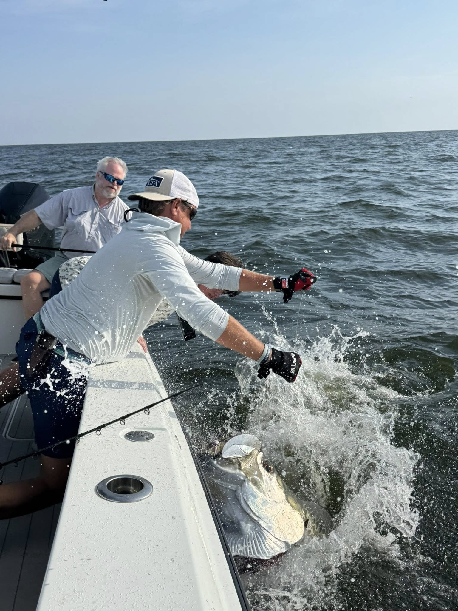 A guide working with a client on the water, photographed by Still Water Fishing Charters in MS