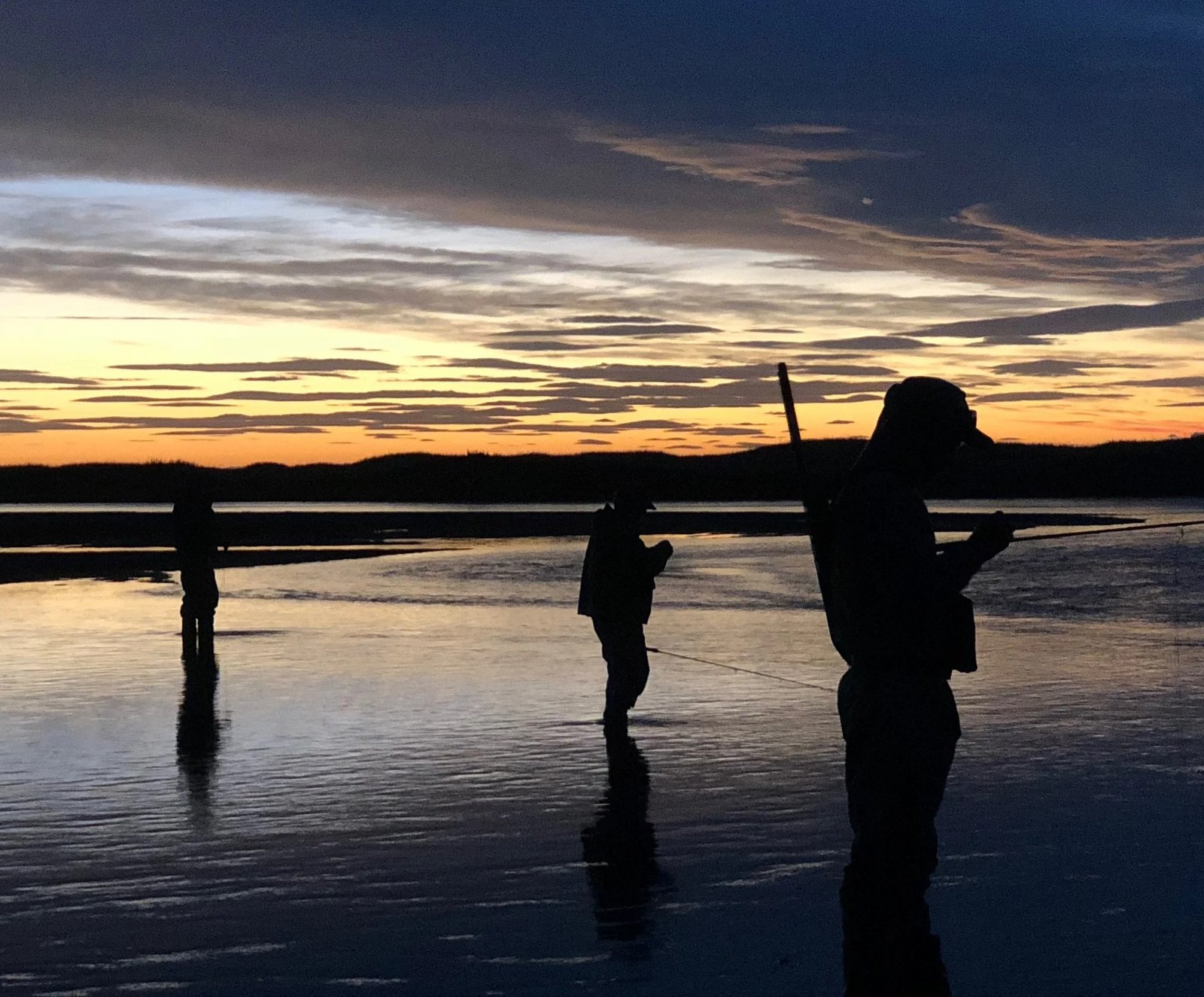 A guide working with a client on the water, photographed by Storey's Fly Fishing in OR