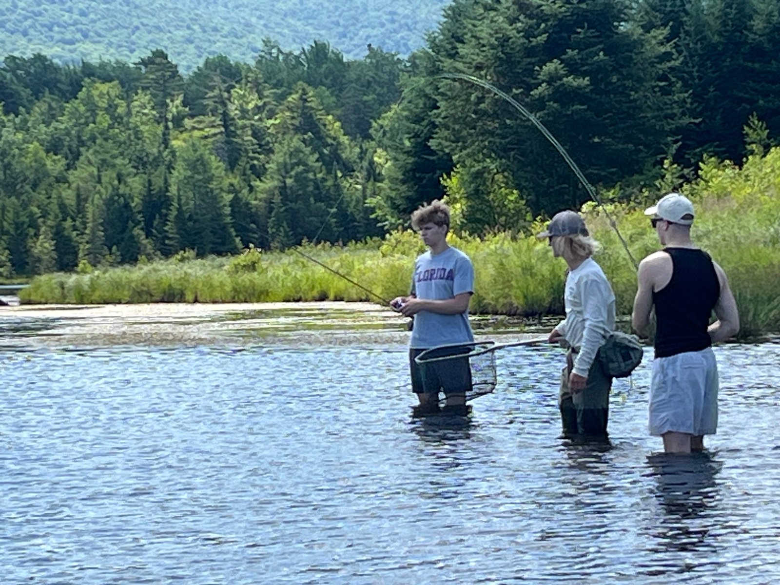 A guide working with a client on the water, photographed by Stream and Brook Fly Fishing in VT