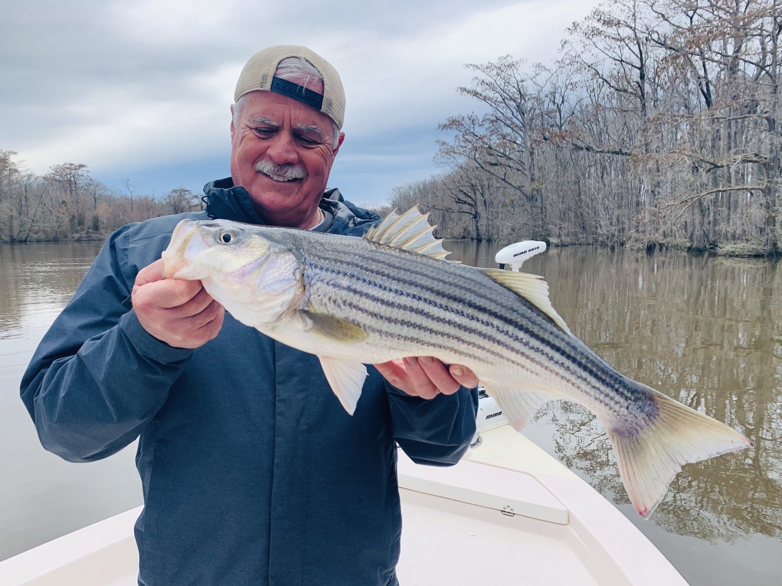A guide working with a client on the water, photographed by Tar-Pam Guide Service in NC