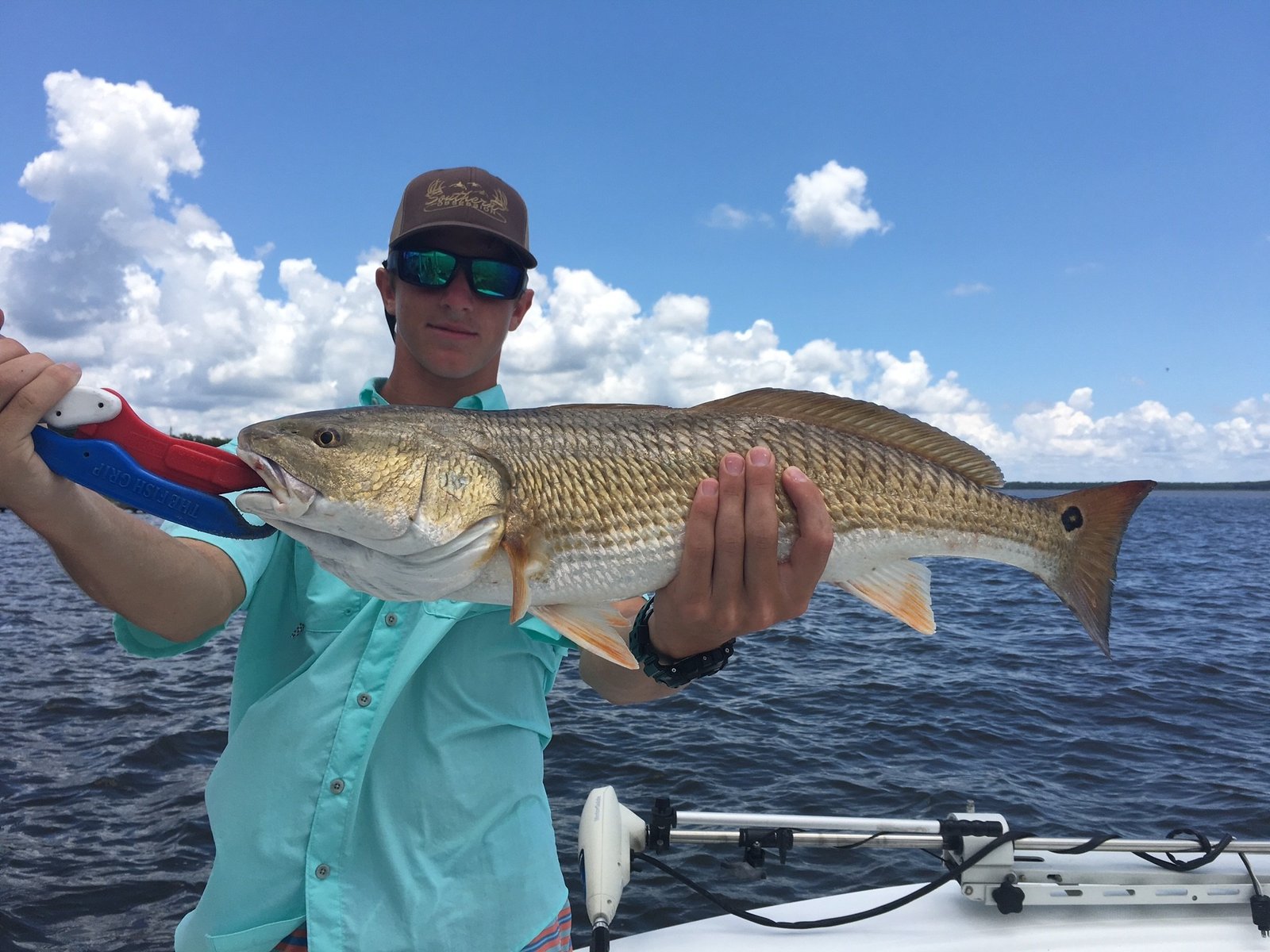 A guide working with a client on the water, photographed by Team Brodie Charters in MS