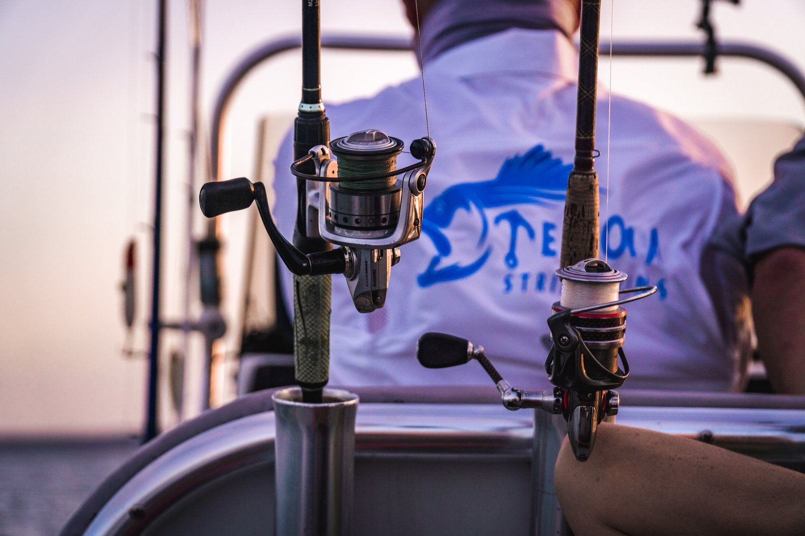 A guide working with a client on the water, photographed by Texoma Striper Kings in TX