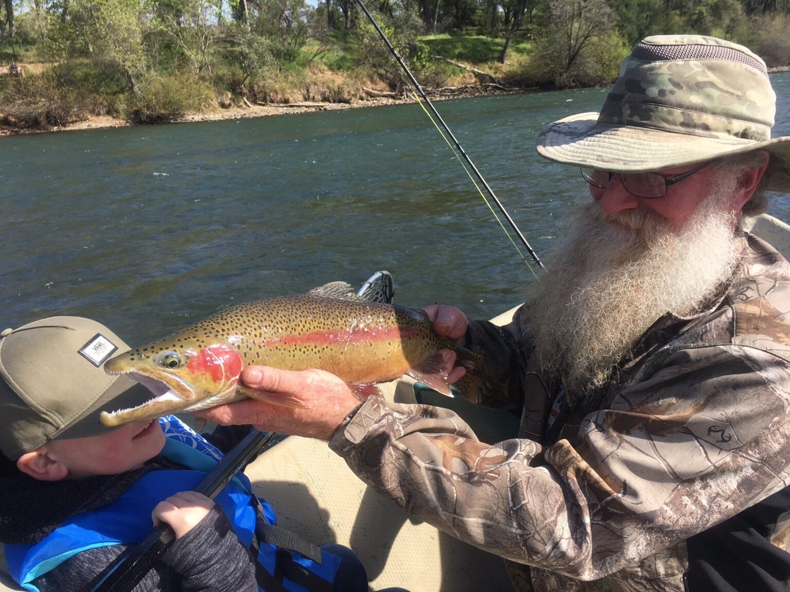 A guide working with a client on the water, photographed by Tightline Connection Fishing Guide Service in CA