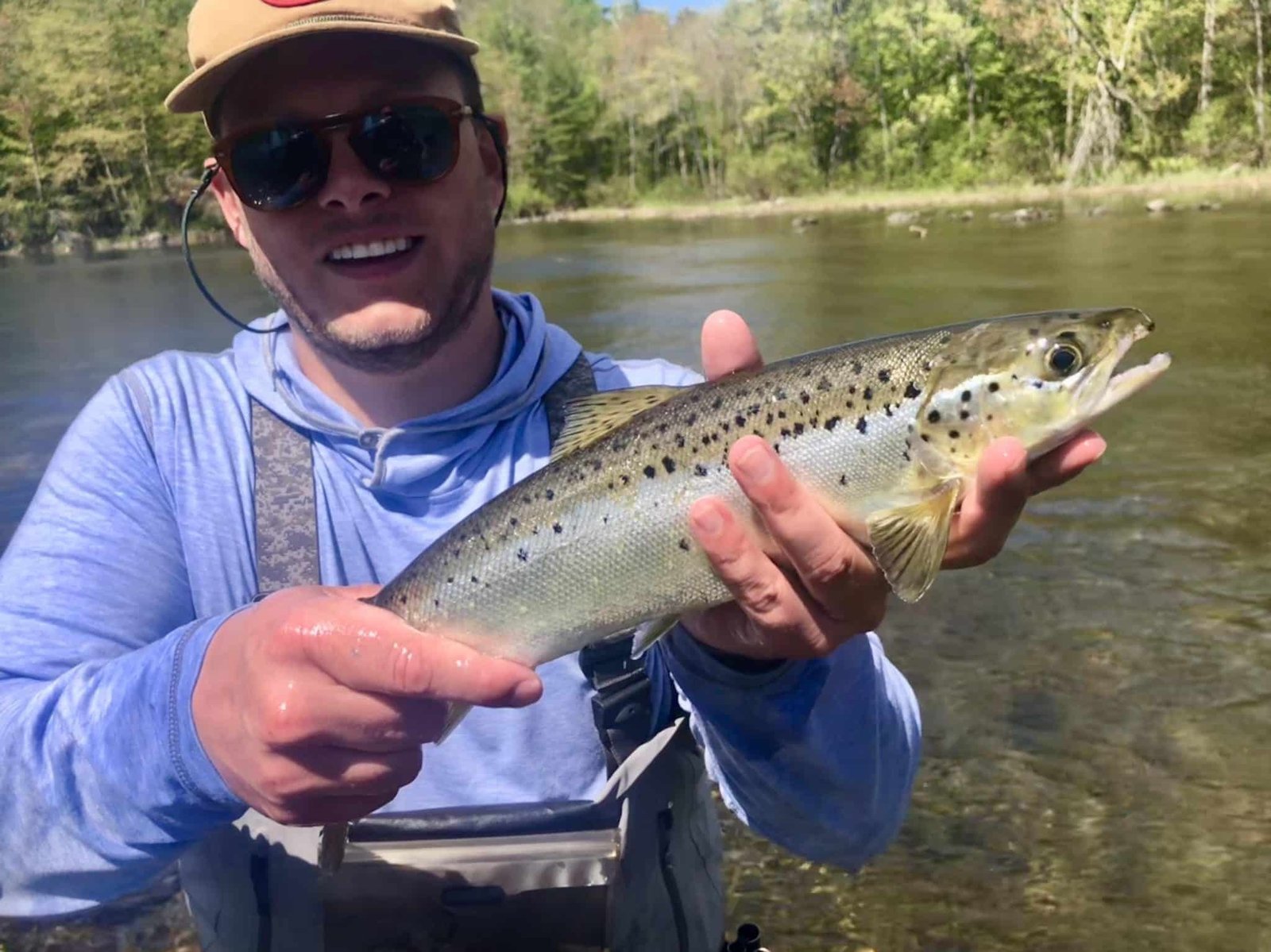 A guide working with a client on the water, photographed by Tracewski Fishing Adventures in ME