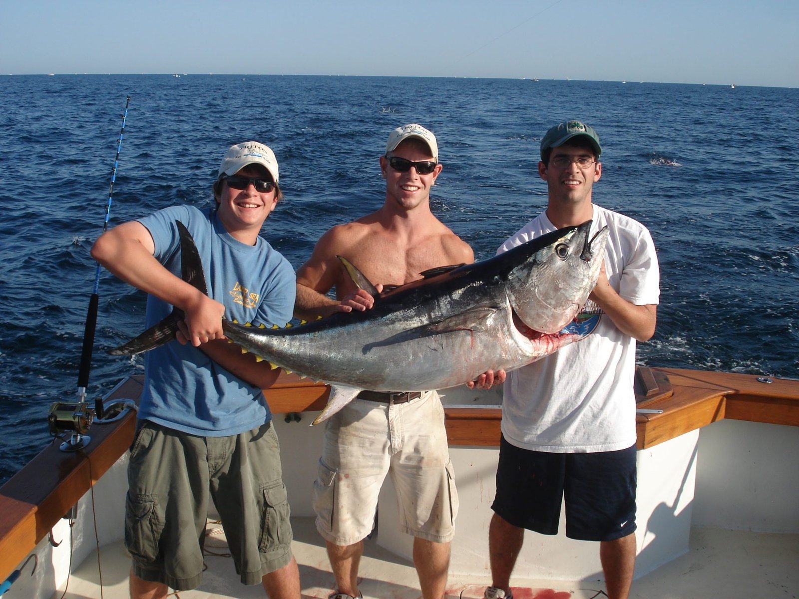 A guide working with a client on the water, photographed by Triton Sportfishing in MA